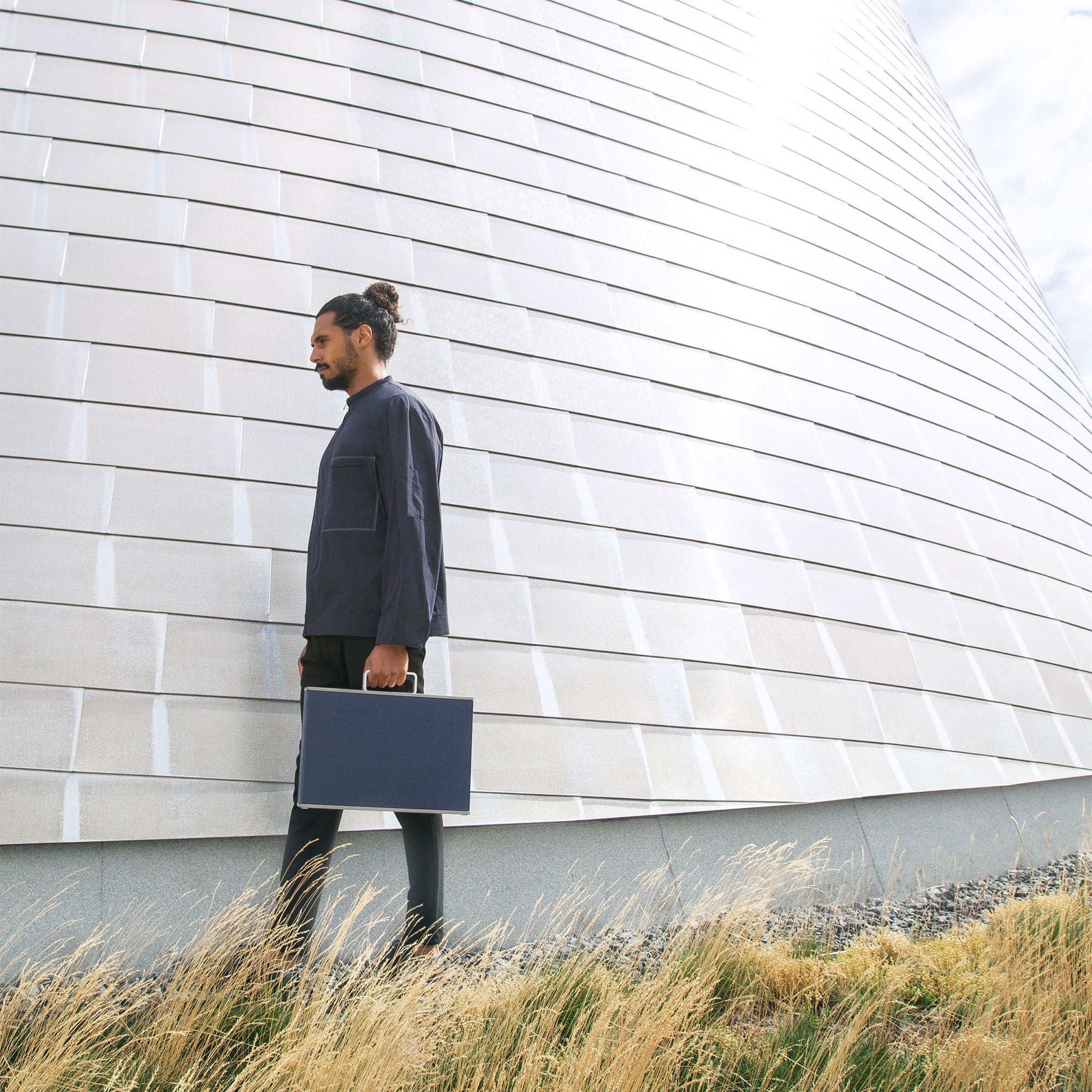 Charles Simon Mackenzie briefcase in marine men's lifestyle in front of modern minimalist architectural structure