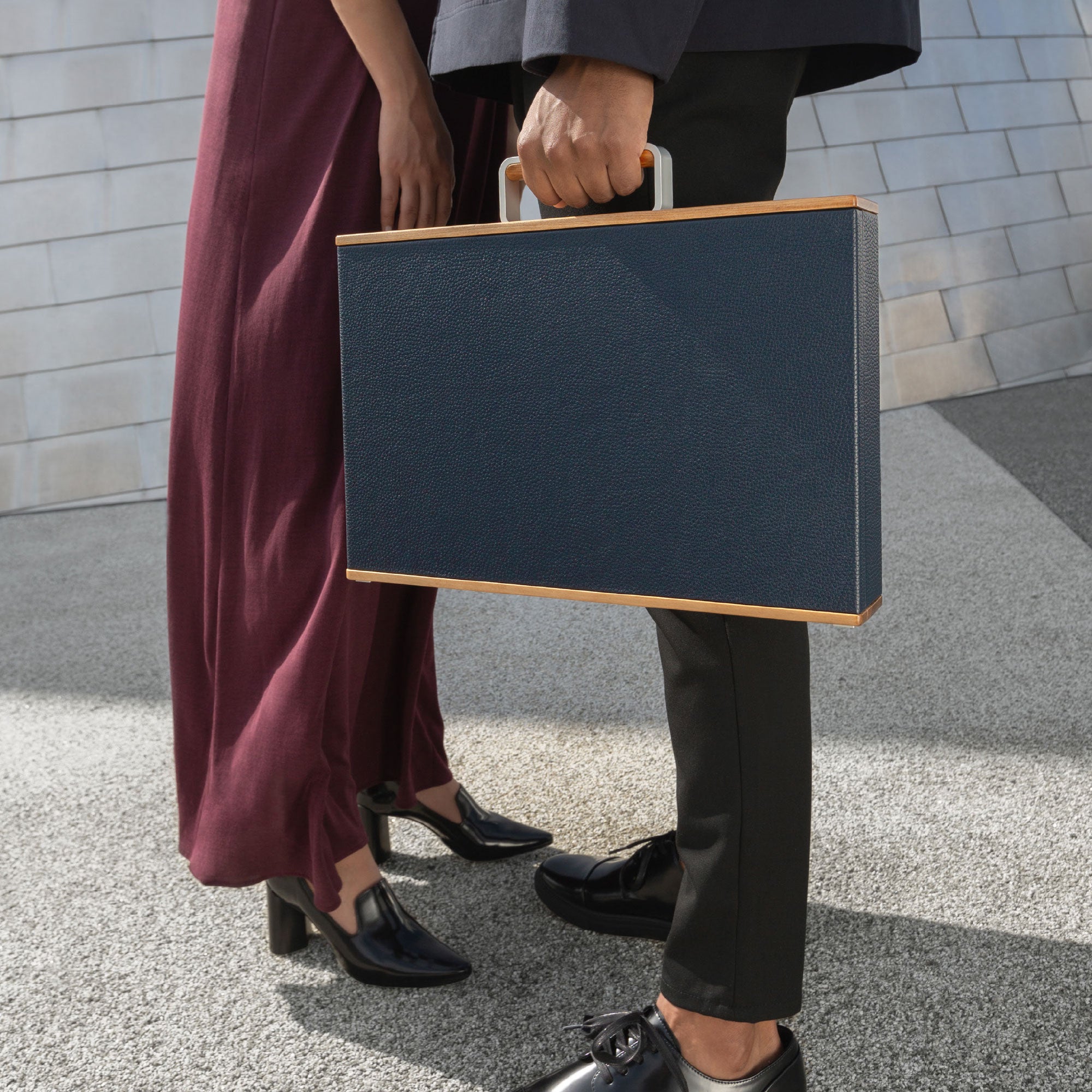 Lifestyle photo of man and woman holding Original Charles Simon Mackenzie briefcase in marine leather