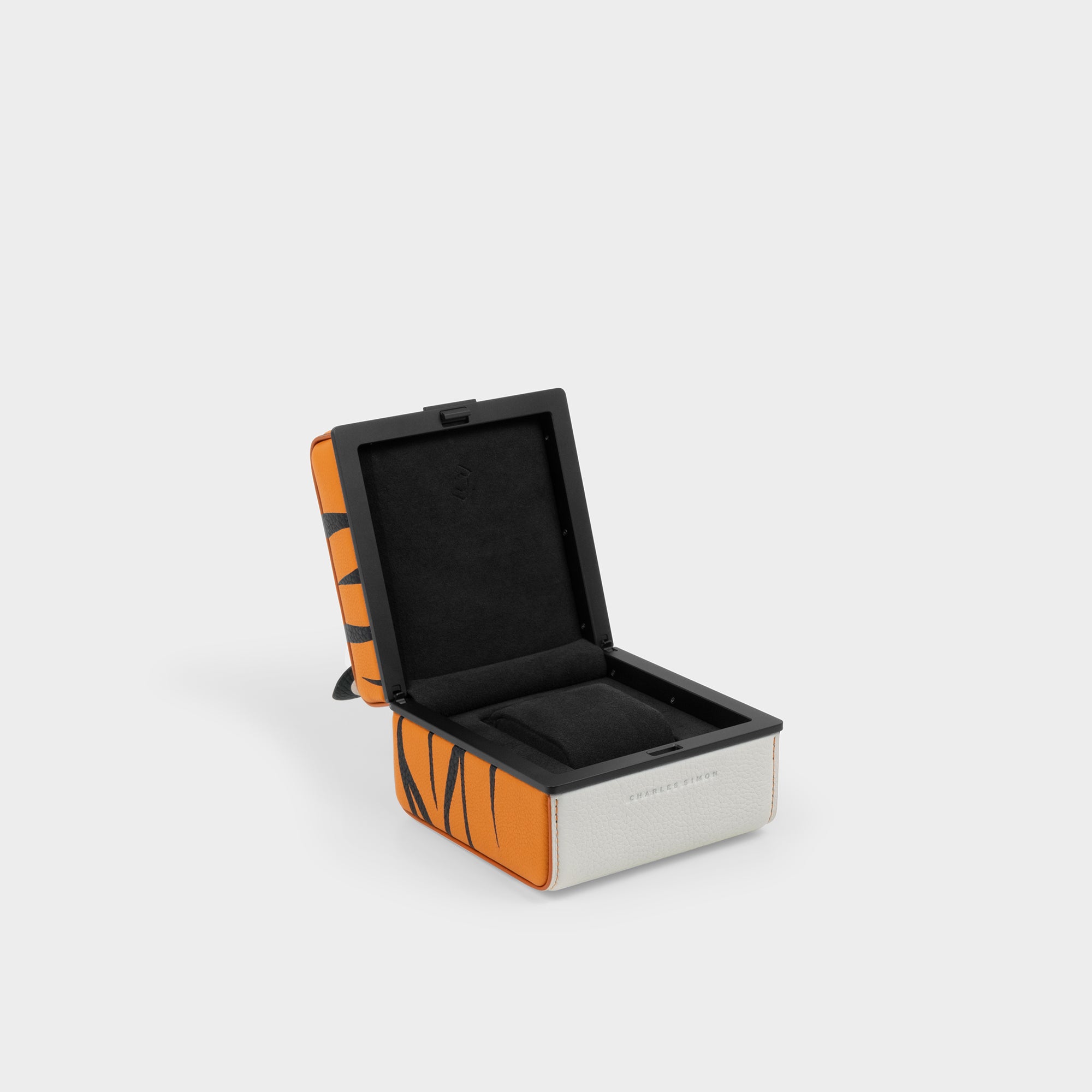 Product photo of open Eaton 1 Special edition watch case featuring a playful tiger design. The watch case interior is lined with black Alcantara and features 1 removable watch cushion.