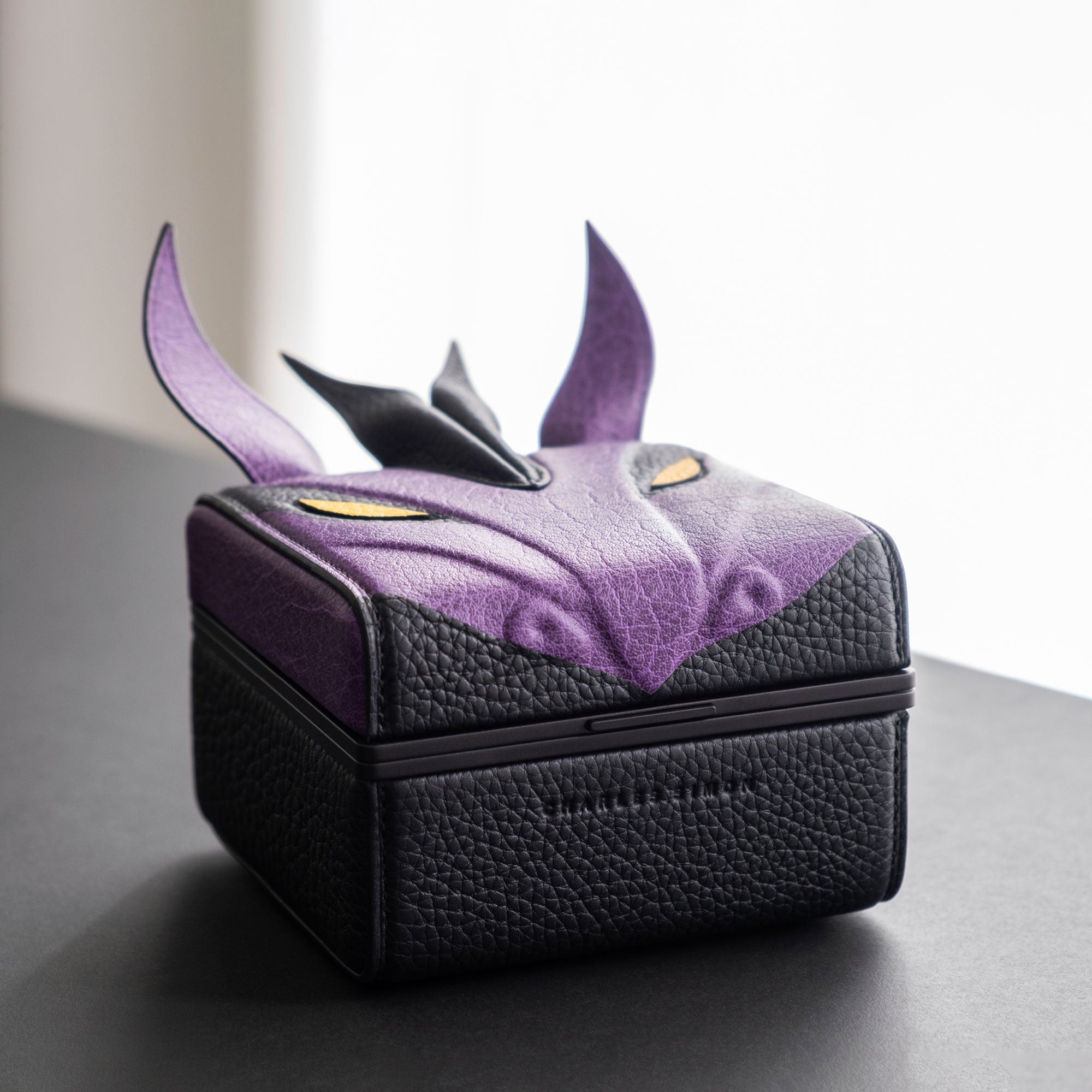 Lifestyle photo of the purple Eaton 1 dragon watch case showing the detailed leather marquetry that went into its creation.