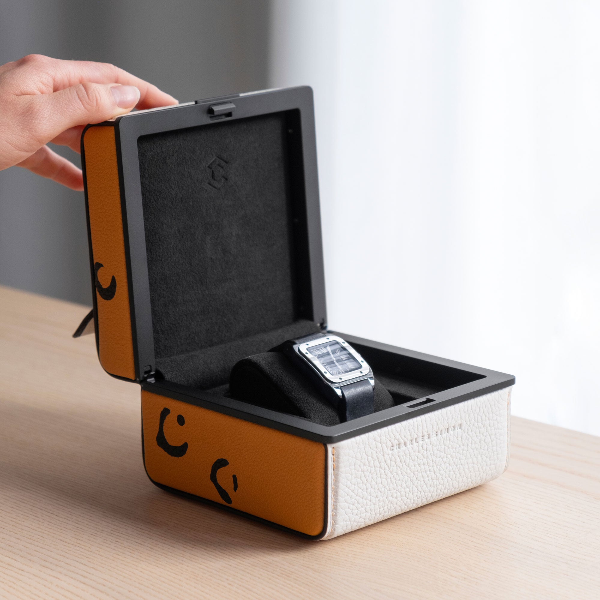 Lifestyle photo of Leopard Special Edition Eaton 1 Watch case for 1 watch being opened. A Cartier watch is placed on a black removable watch cushion. Handmade in Canada.