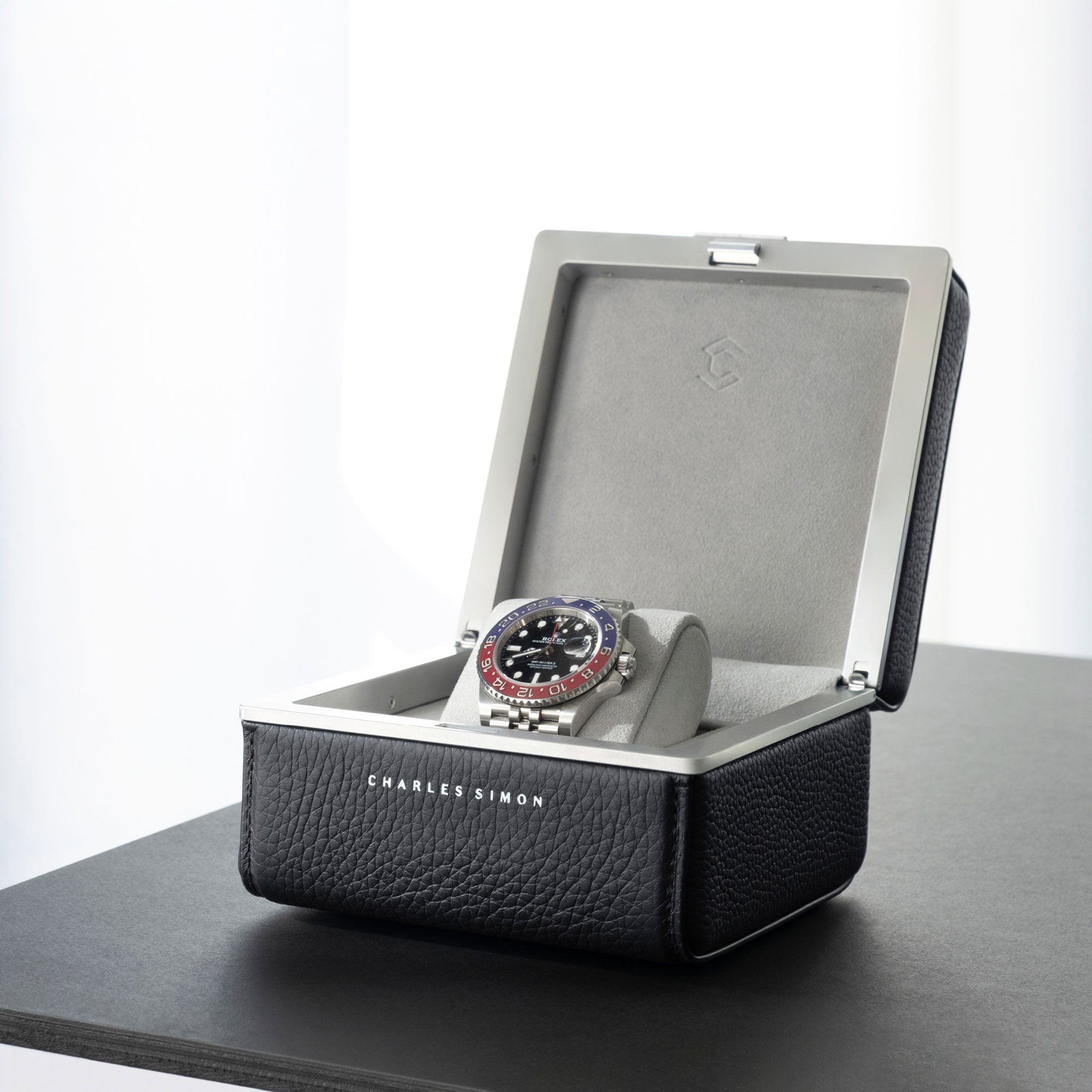 Lifestyle photo of open Eaton 1 Watch case showcasing Rolex Pepsi luxury watch.
