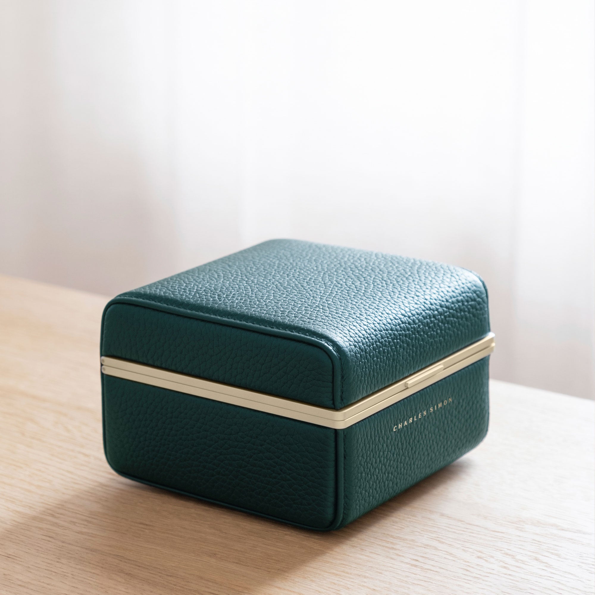 Lifestyle photo of closed emerald leather Eaton 1 gold watch case for 1 watch. Handmade to transport, hold and showcase your favorite watch.