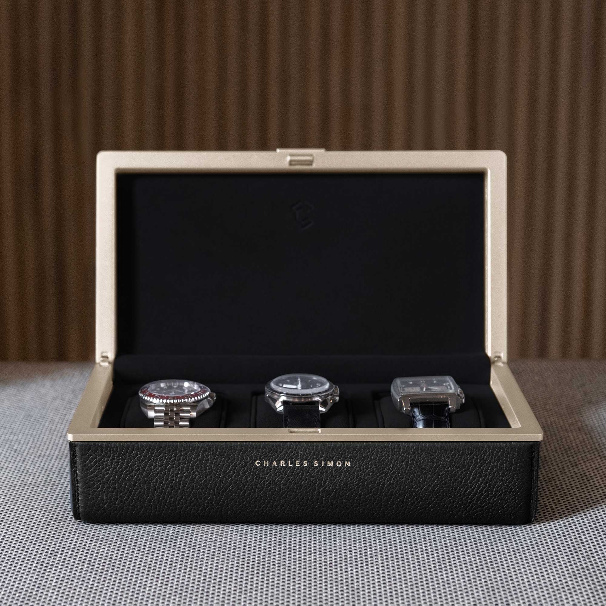 3 luxury watches elegantly displayed in the Eaton 3 Watch case in gold casing and black leather.