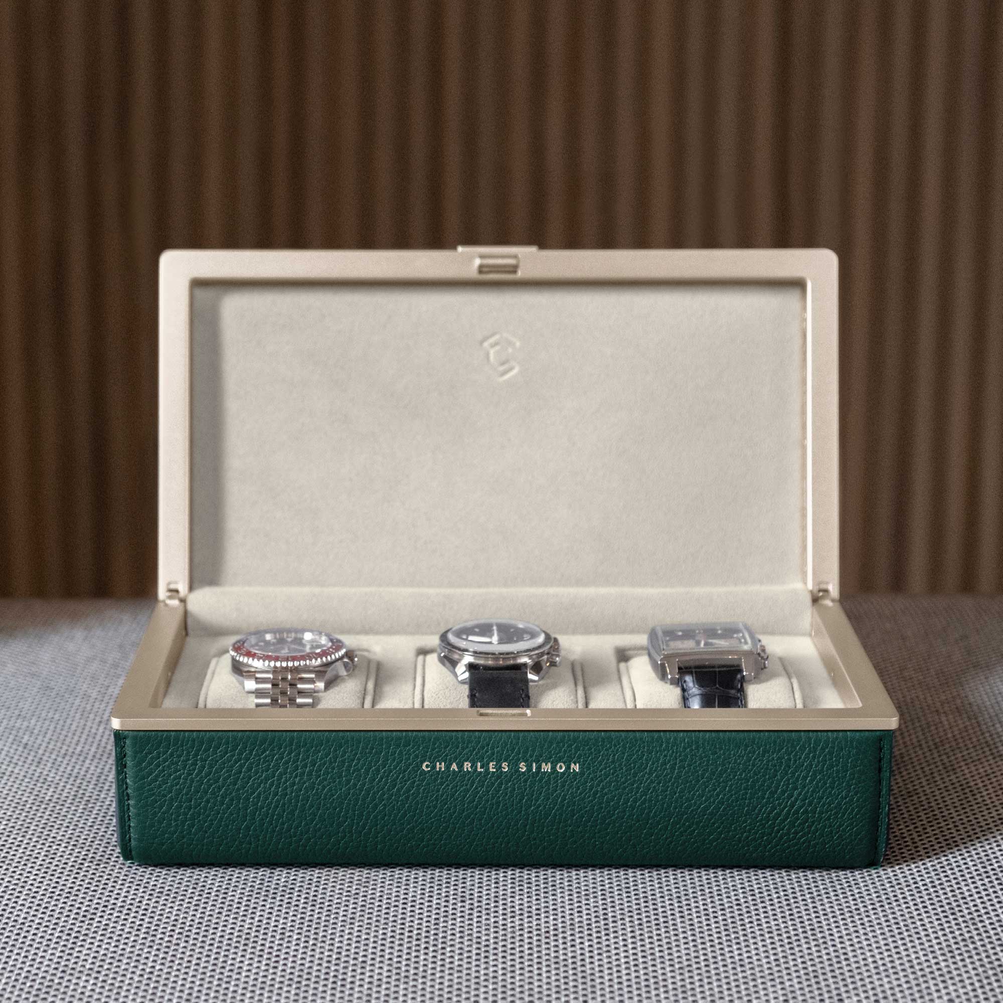3 luxury watches elegantly displayed in the Eaton 3 Watch case in gold casing and emerald leather.