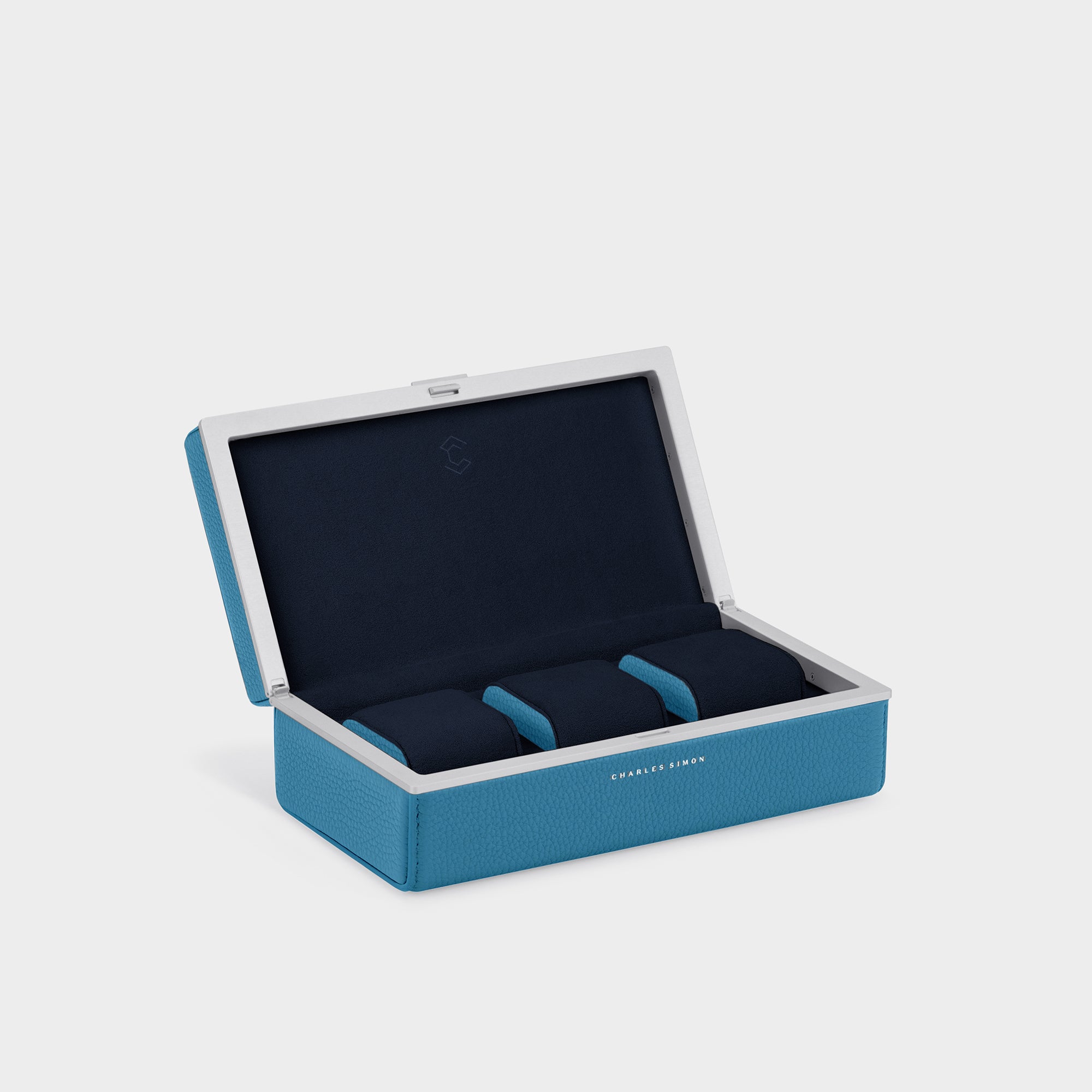 Charles Simon Eaton watch case for 3 watches. Handmade from sky blue premium French leather , deep blue Alcantara and anodized aluminum. Featuring colorful sky blue leather accents on the sides of the three removable Alcantara cushions