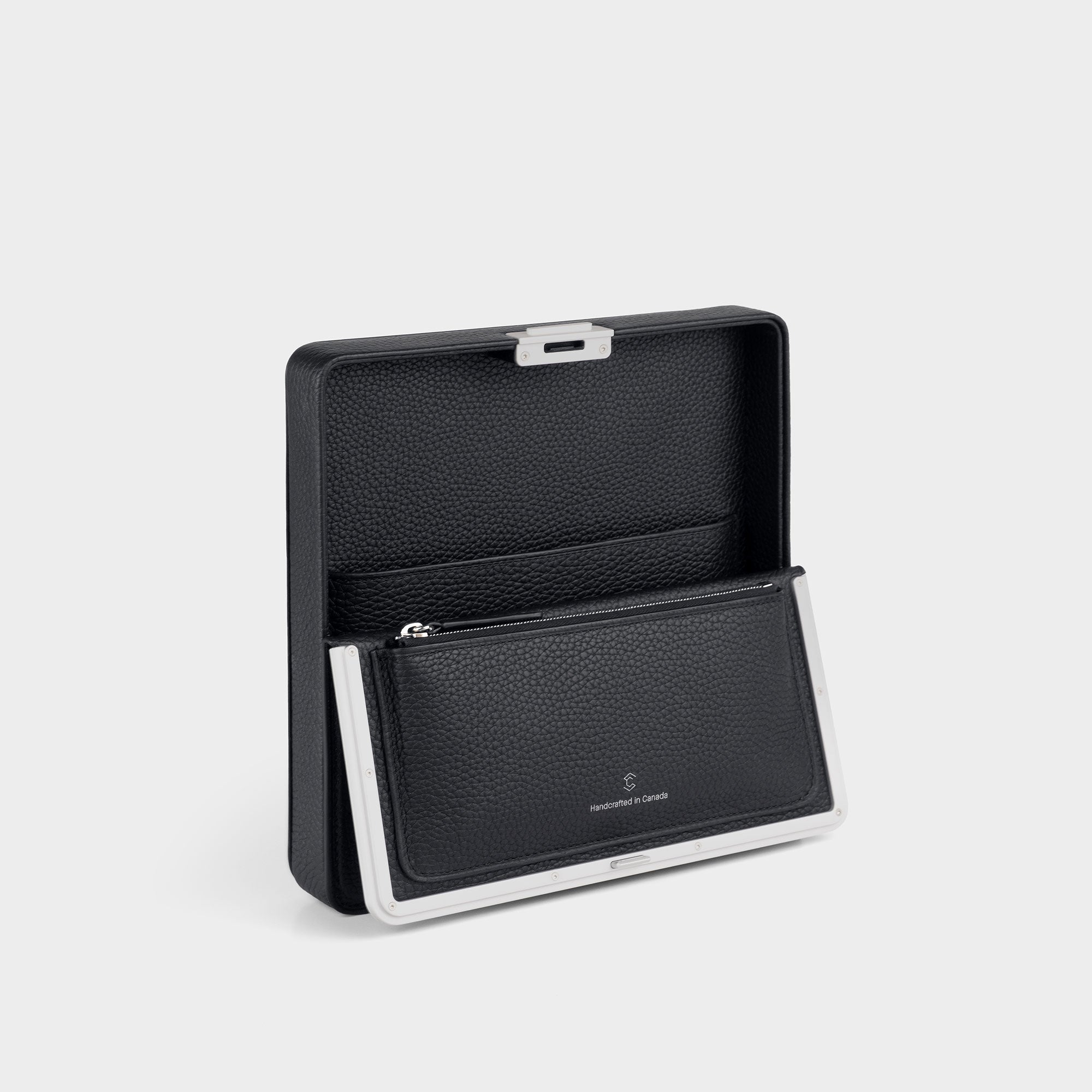 Charles Simon Fraser wallet in black leather open view, showcasing the zipped pouch and convenient compartment for travel belongings.