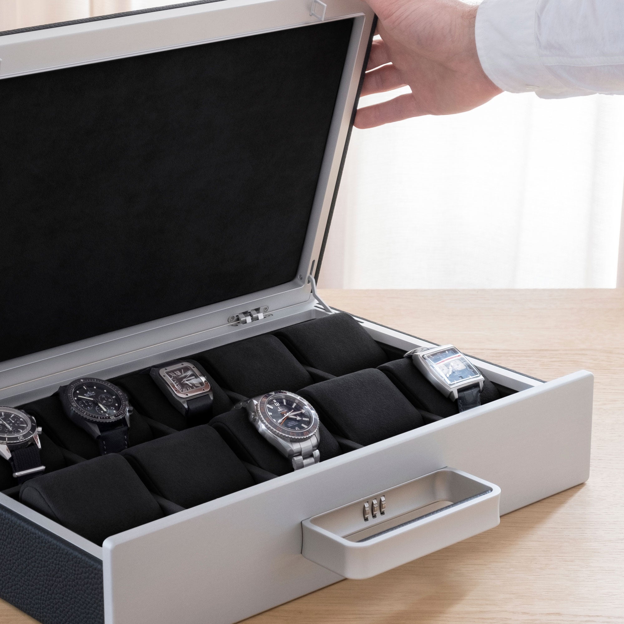Lifestyle shot of Mackenzie Watch briefcase 10 filled with luxury watches including BlancPain, Cartier and Omega