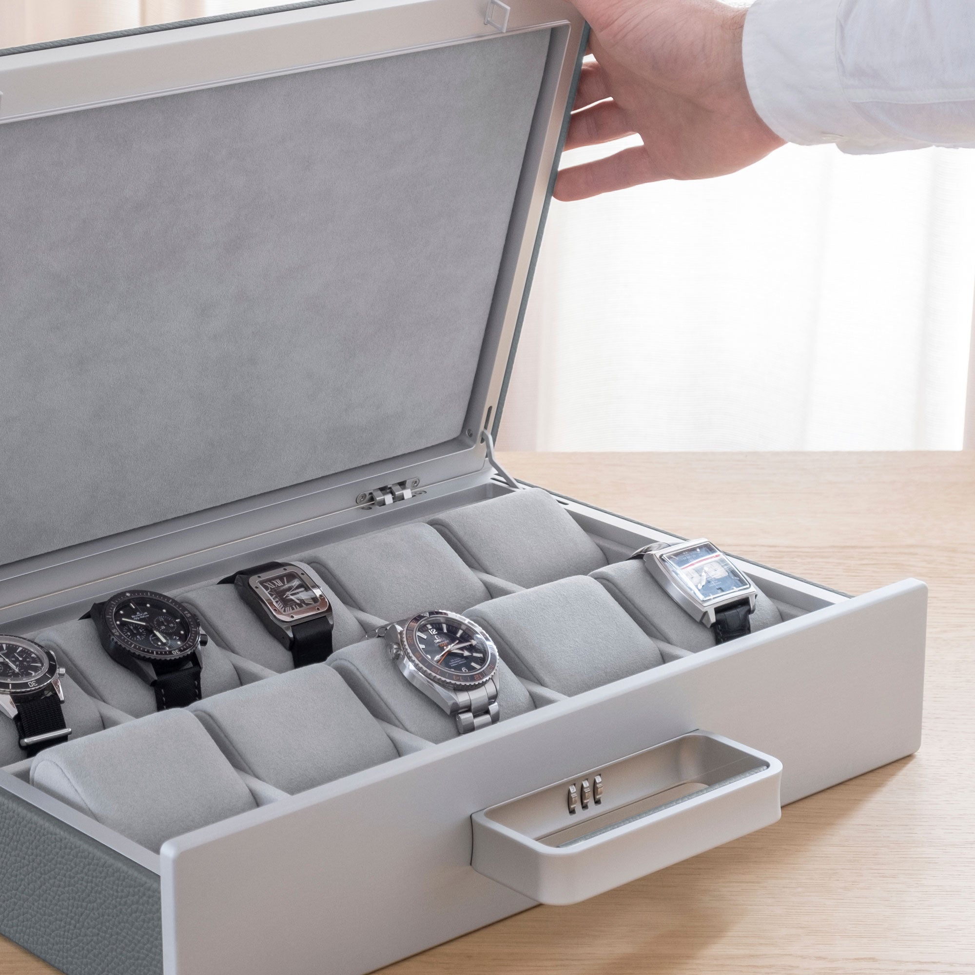 Lifestyle shot of Mackenzie Watch briefcase 10 filled with luxury watches including Blancpain, Tag Heuer and Jaeger-LeCoultre