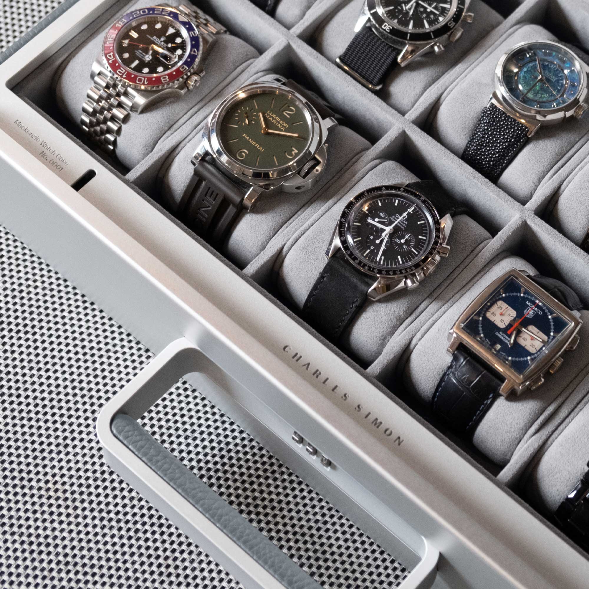 Lifestyle shot of Charles Simon handmade watch briefcase filled with luxury watches including Rolex, Panerai and Omega