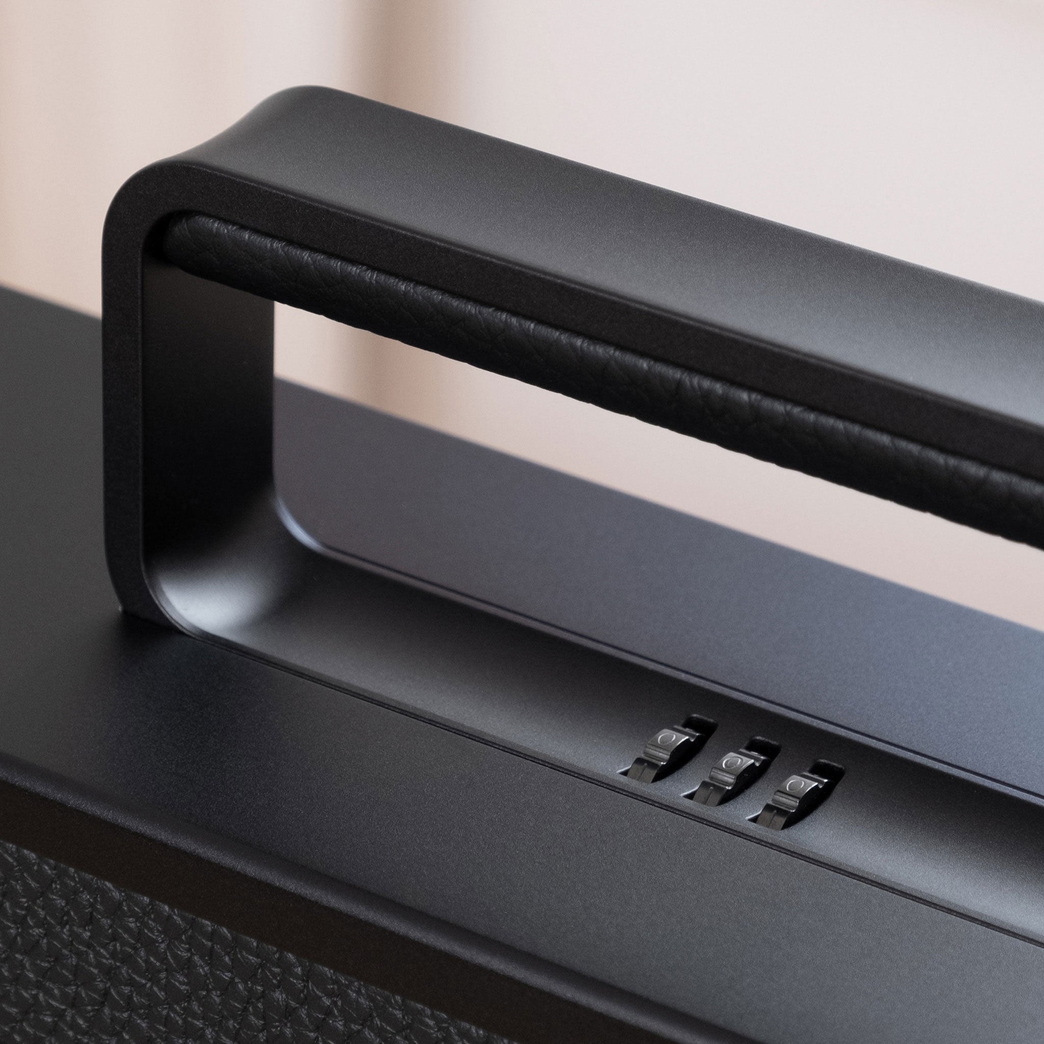 Closeup shot of Mackenzie 10 watch cases in all black showcasing sleek black aluminum handles and locks with personalized code