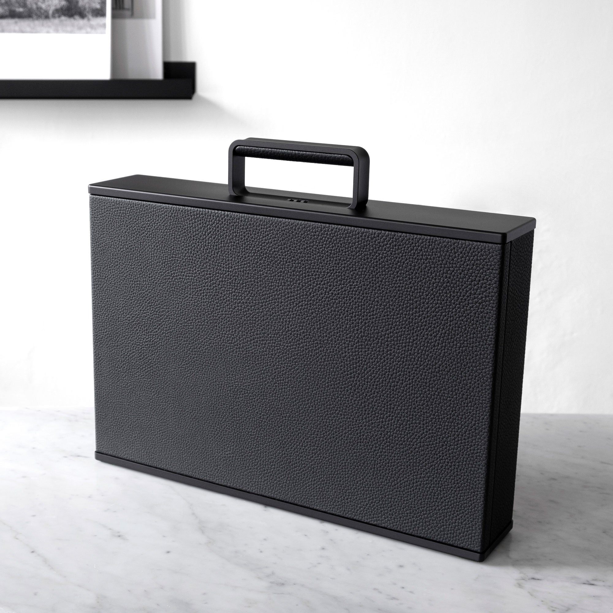 Lifestyle photo of all black Mackenzie briefcase. Handmade in Canada.