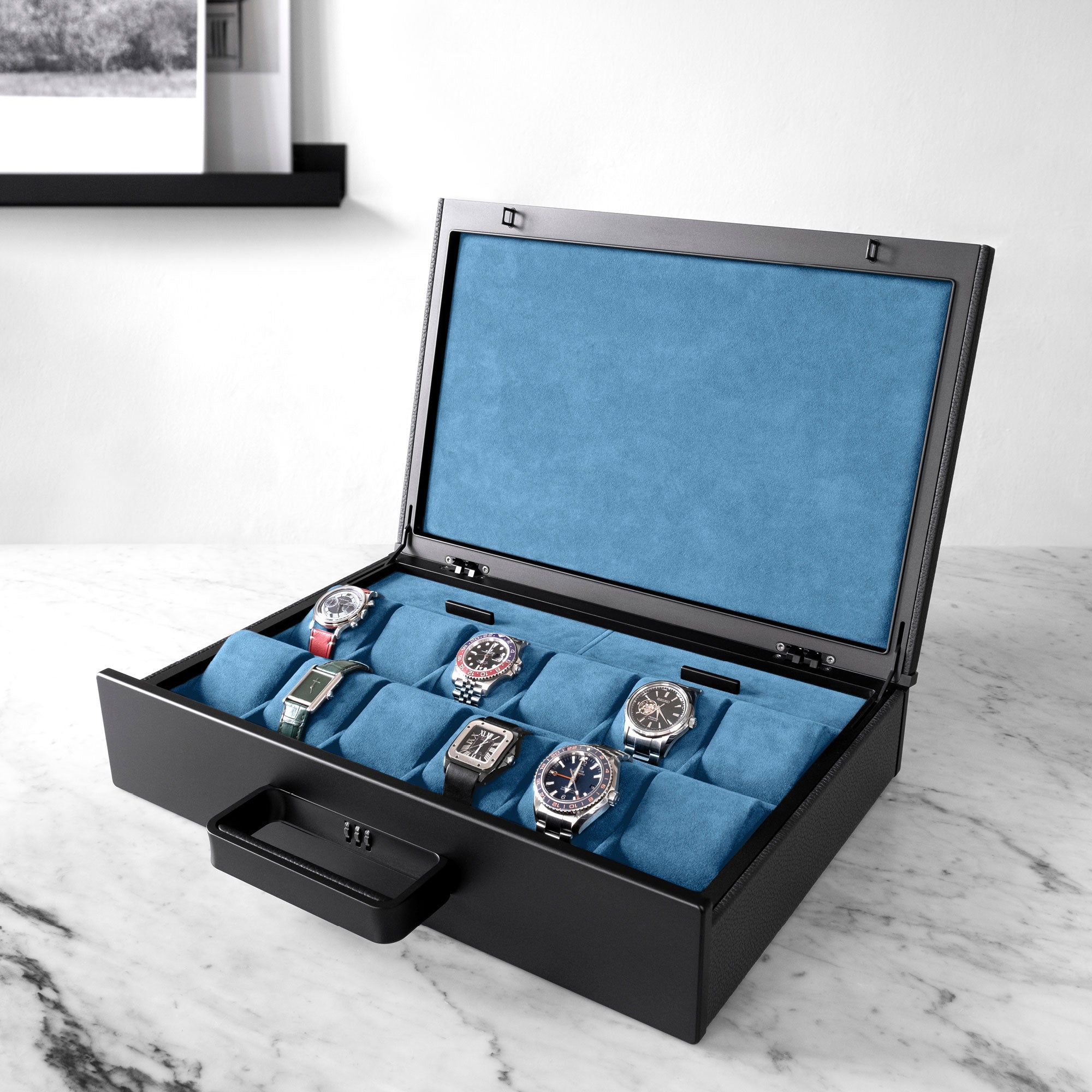 Designer watch briefcase in black leather, black carbon fiber and anodized aluminum and cyan blue Alcantara interior holding luxury watches