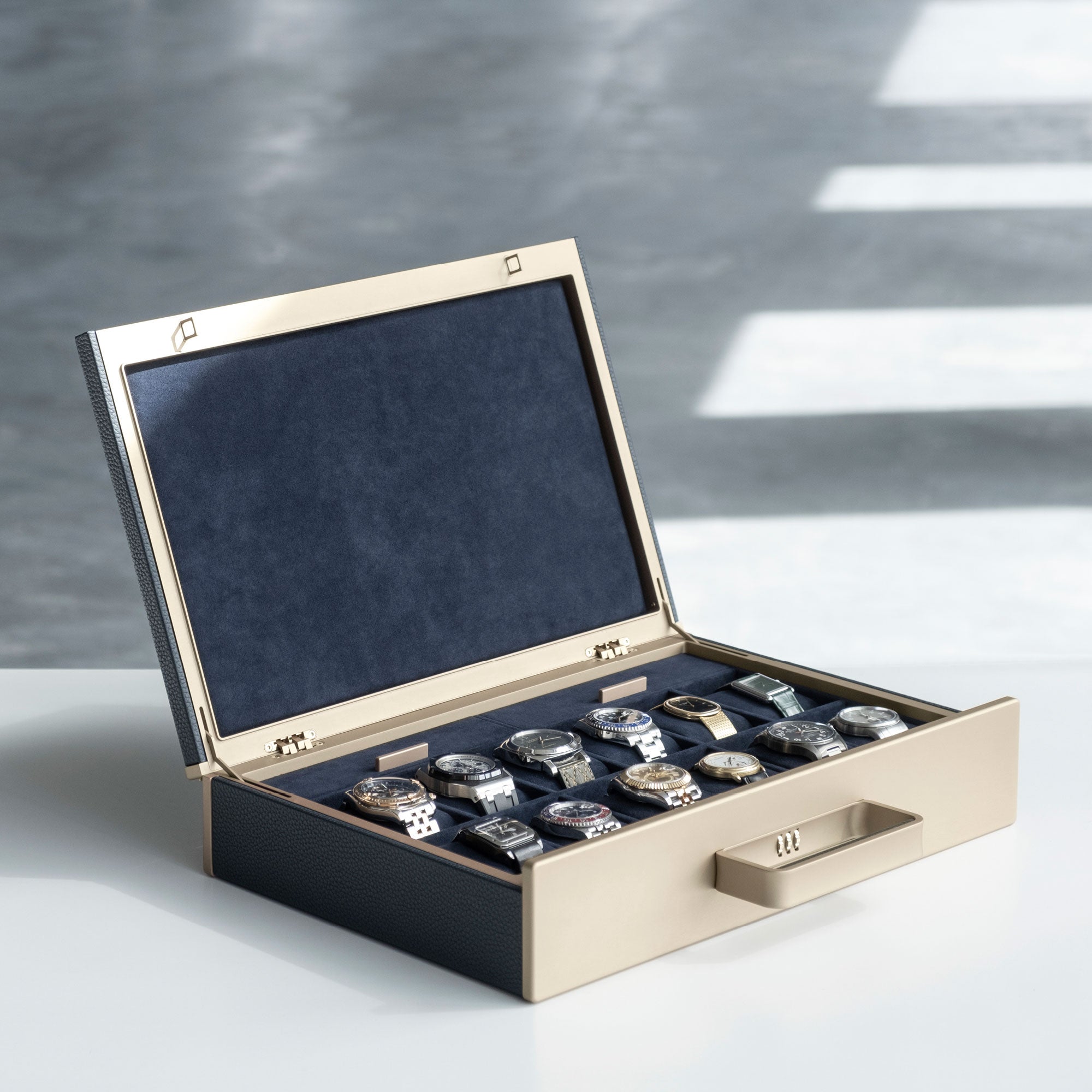 Lifestyle photo of gold Mackenzie 12 Watch briefcase displaying an entire watch collection of 12 luxury timepieces. Handmade in Canada to store, transport and display your watches