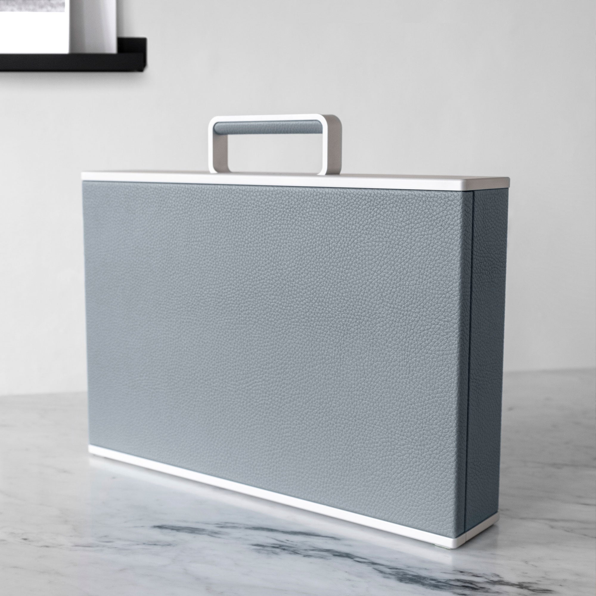 Lifestyle shot of Charles Simon Watch briefcase in cloud grey leather and grey anodized aluminum made by hand in Canada