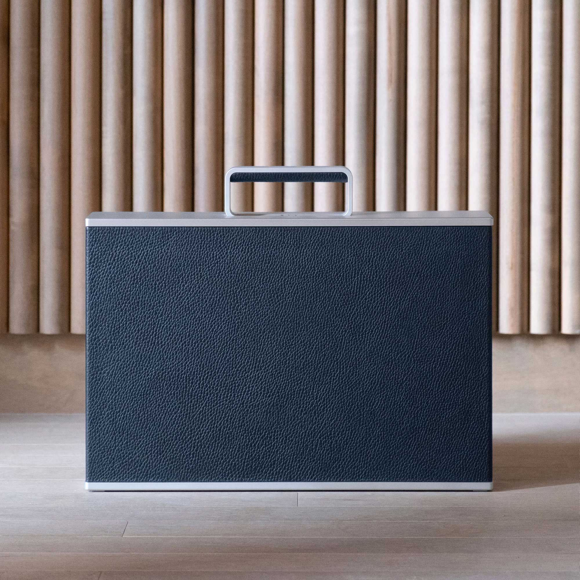 Lifestyle shot showing the front view of the closed Mackenzie Briefcase in marine leather