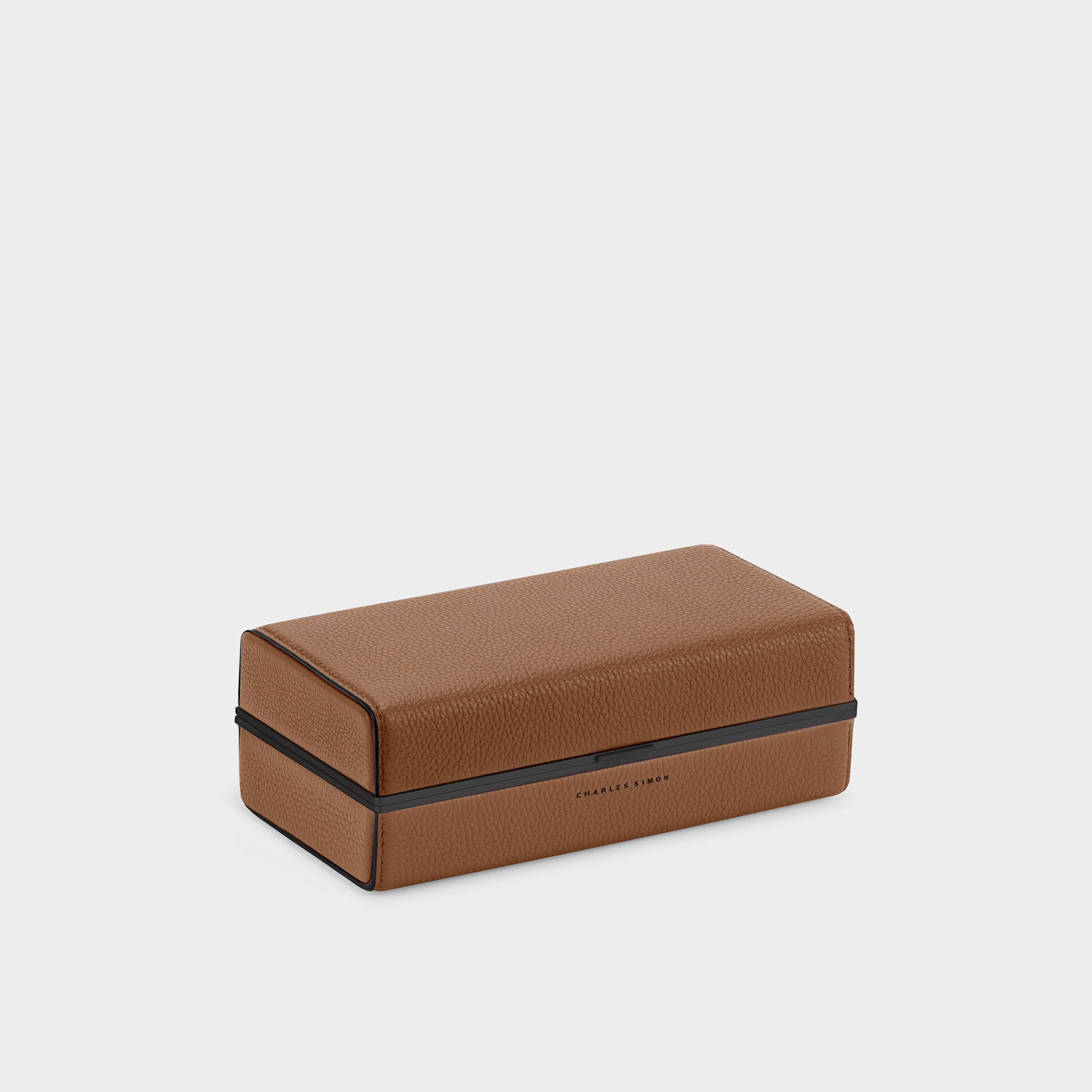 Product photo of the Moraine toiletry bag in tan leather with black edges. Perfect for traveling.