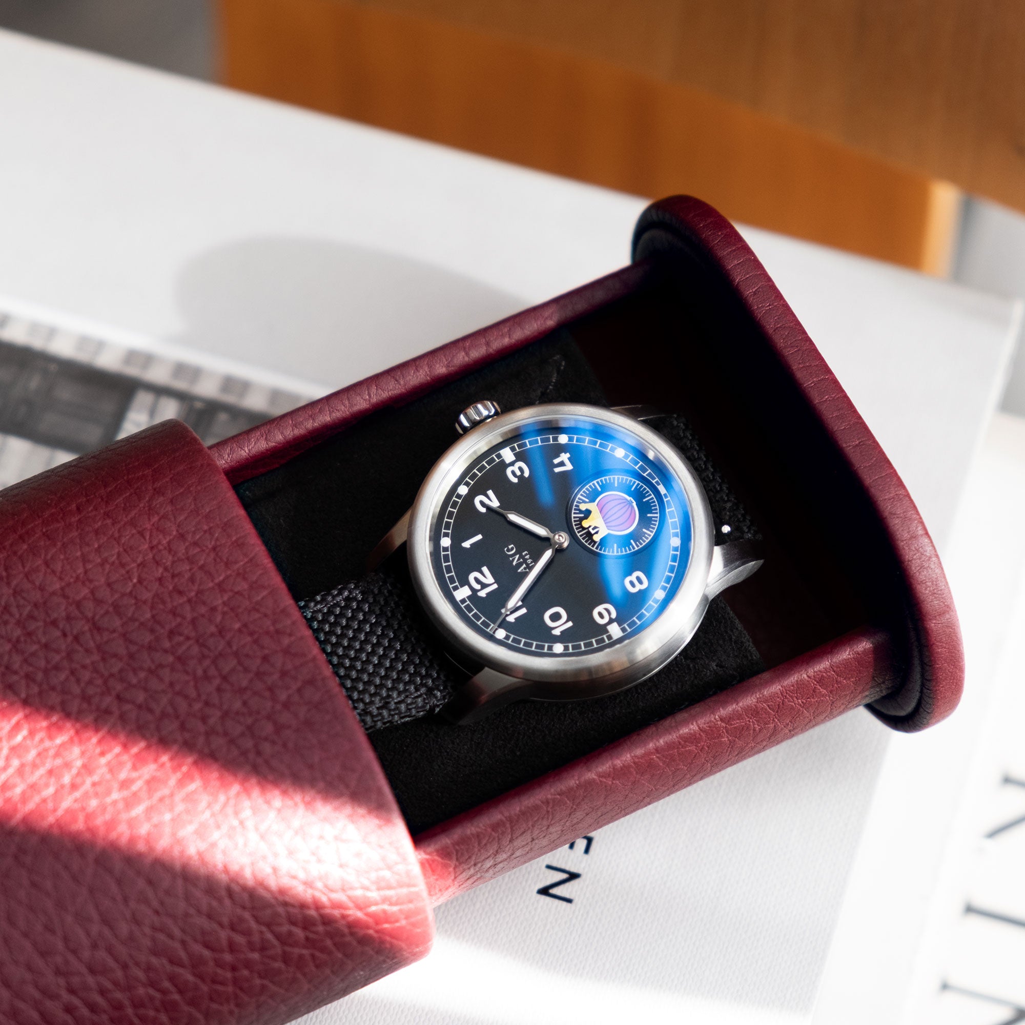 Leather watch roll for a single watch with strap, featuring a sleek design and compact format for safe travel protection.