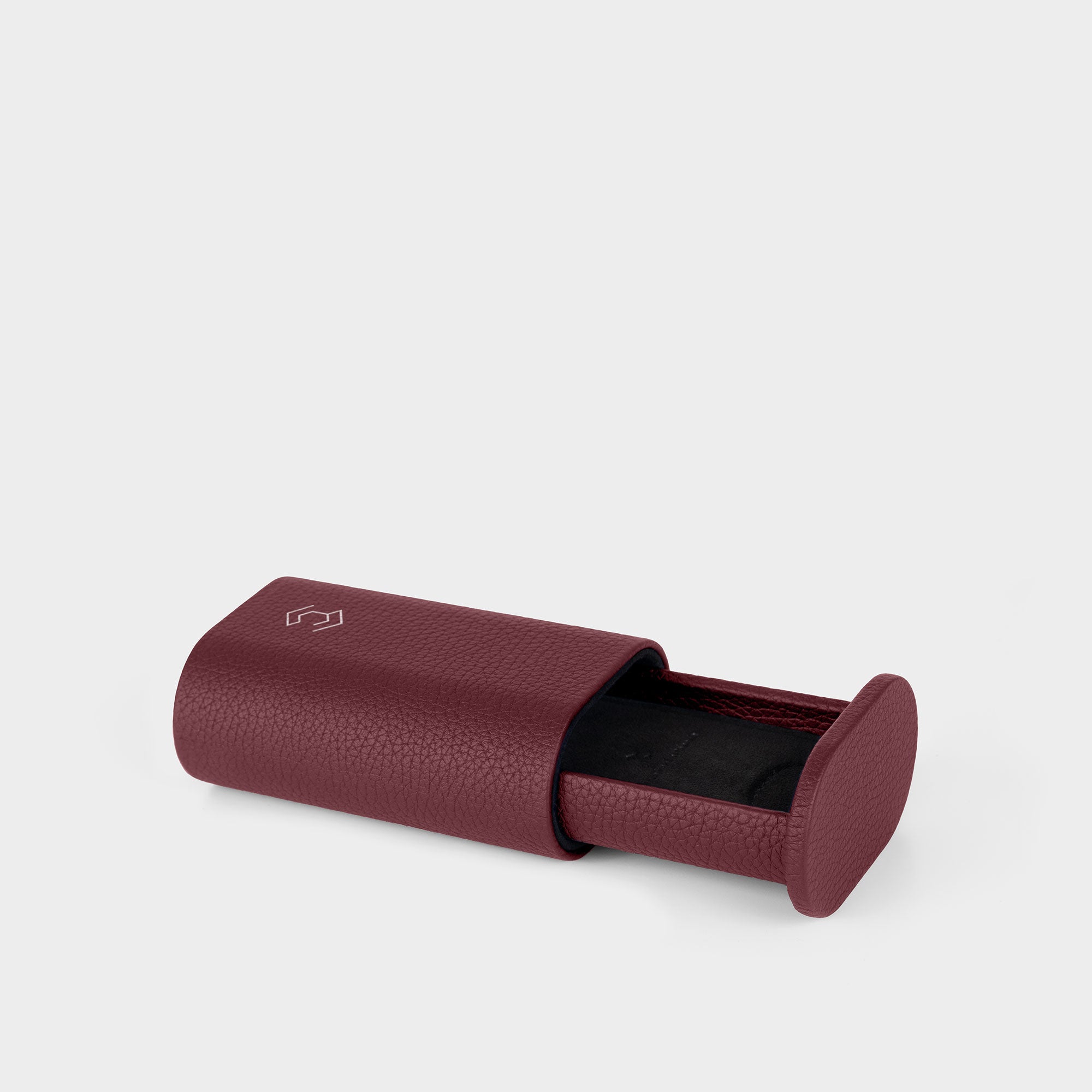 Burgundy leather watch roll with a black interior