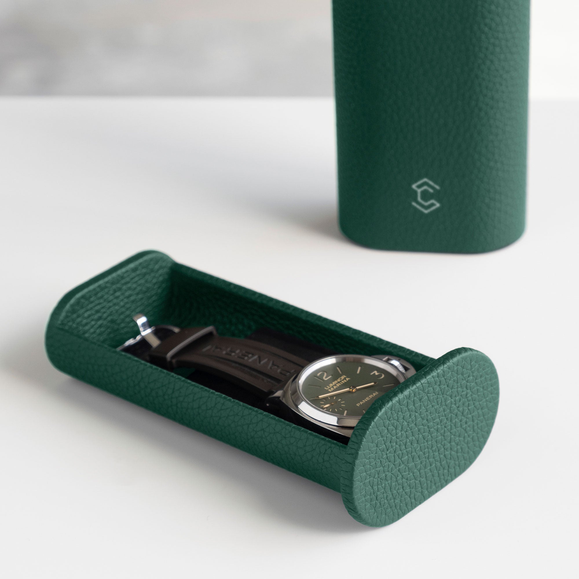Men's watch placed in Oscar Tall Leather Watch roll in emerald green. Handmade in Canada.