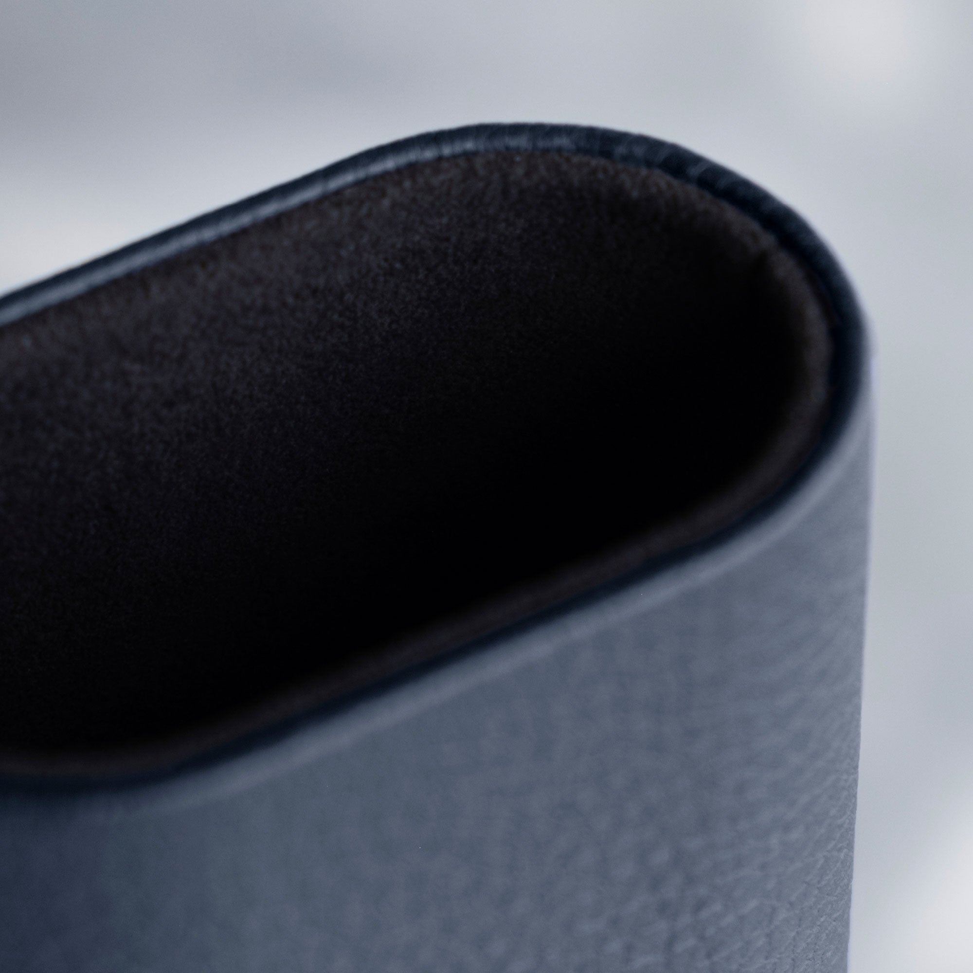 Closeup of marine French Taurillon leather exterior and soft black interior lining of the Charles Simon Travel Watch roll.