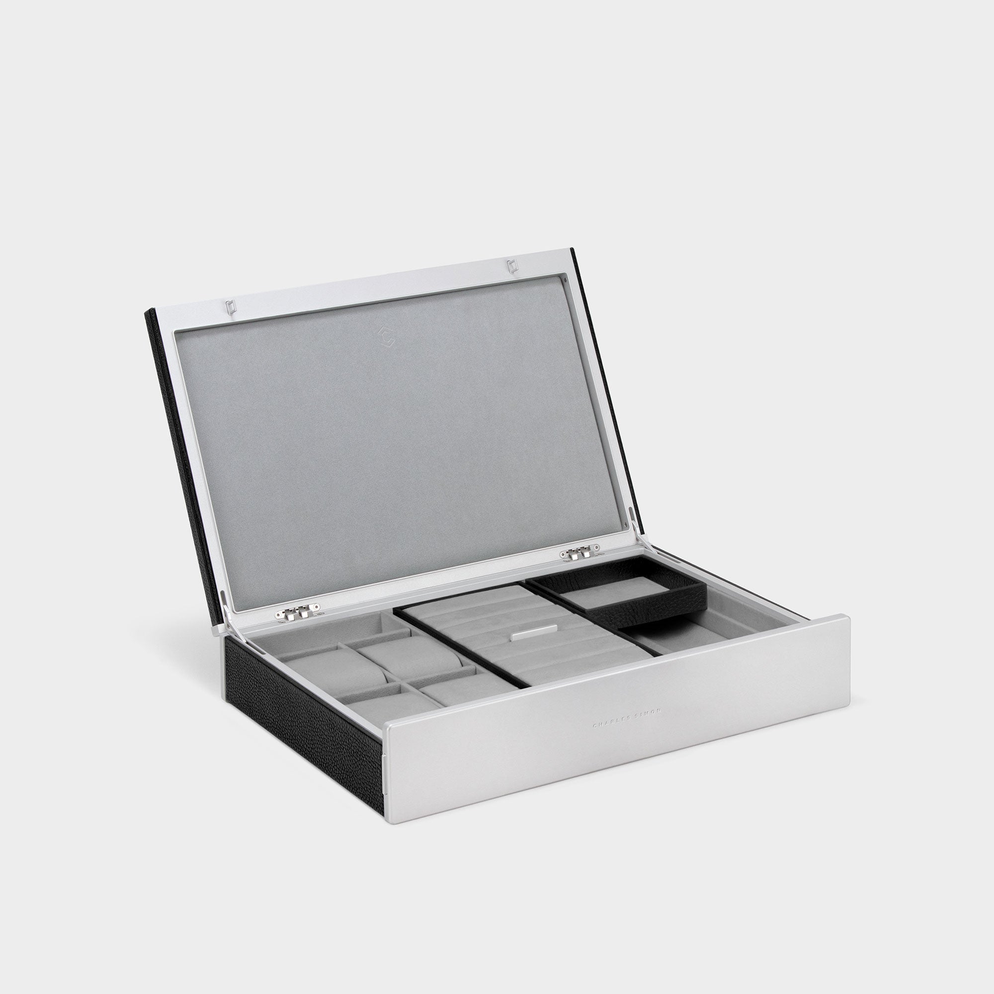 Product photo of open Taylor 4 Watch and Jewelry box in black leather and fog grey interior. Featuring 4 removable watch cushions to store a watch collection of up to 4 watches and multiple removable compartments for earrings, necklaces, bracelets and more at home.