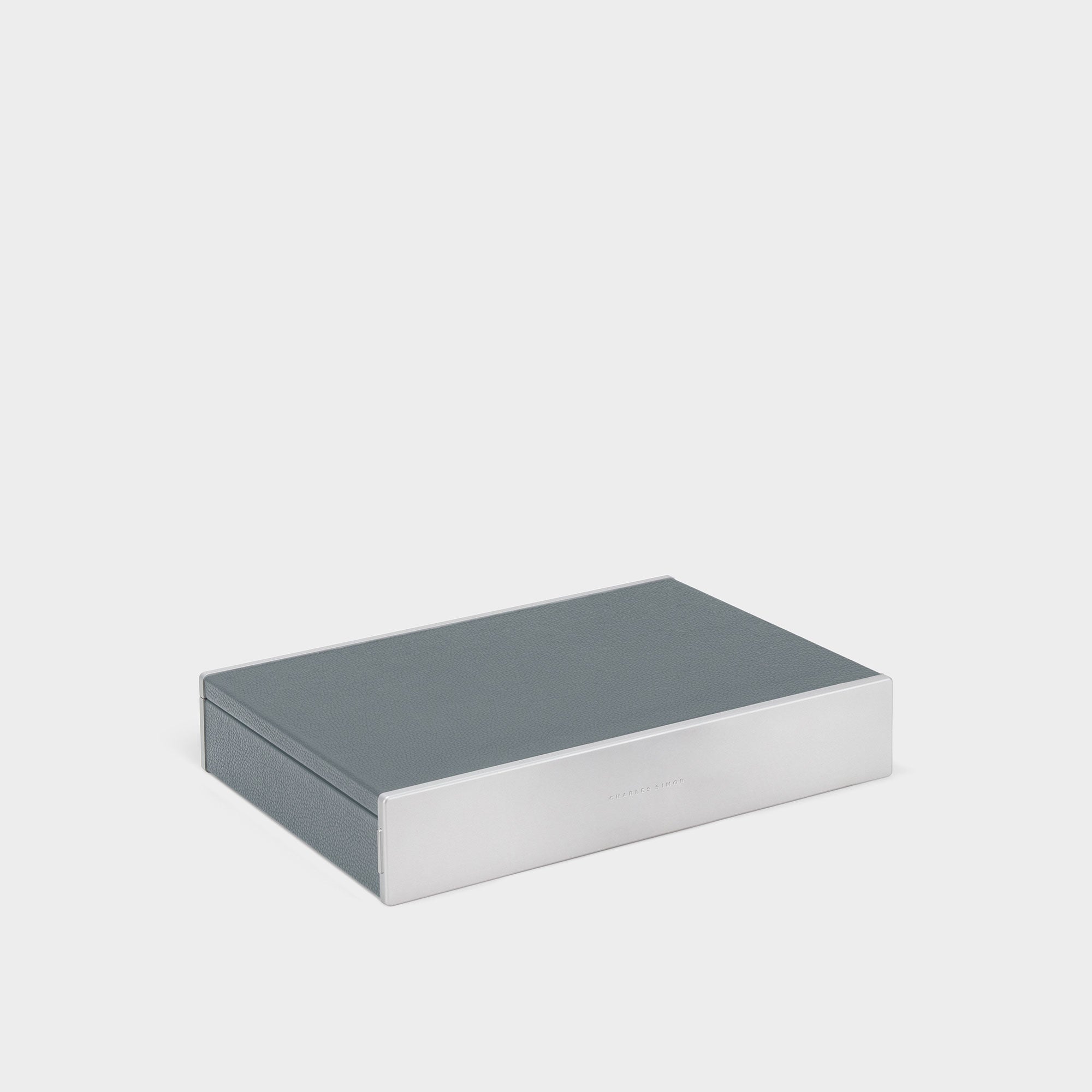 Product photo of closed Taylor 4 Watch and Jewelry box in cloud grey leather and carbon fiber and anodized aluminum casing.