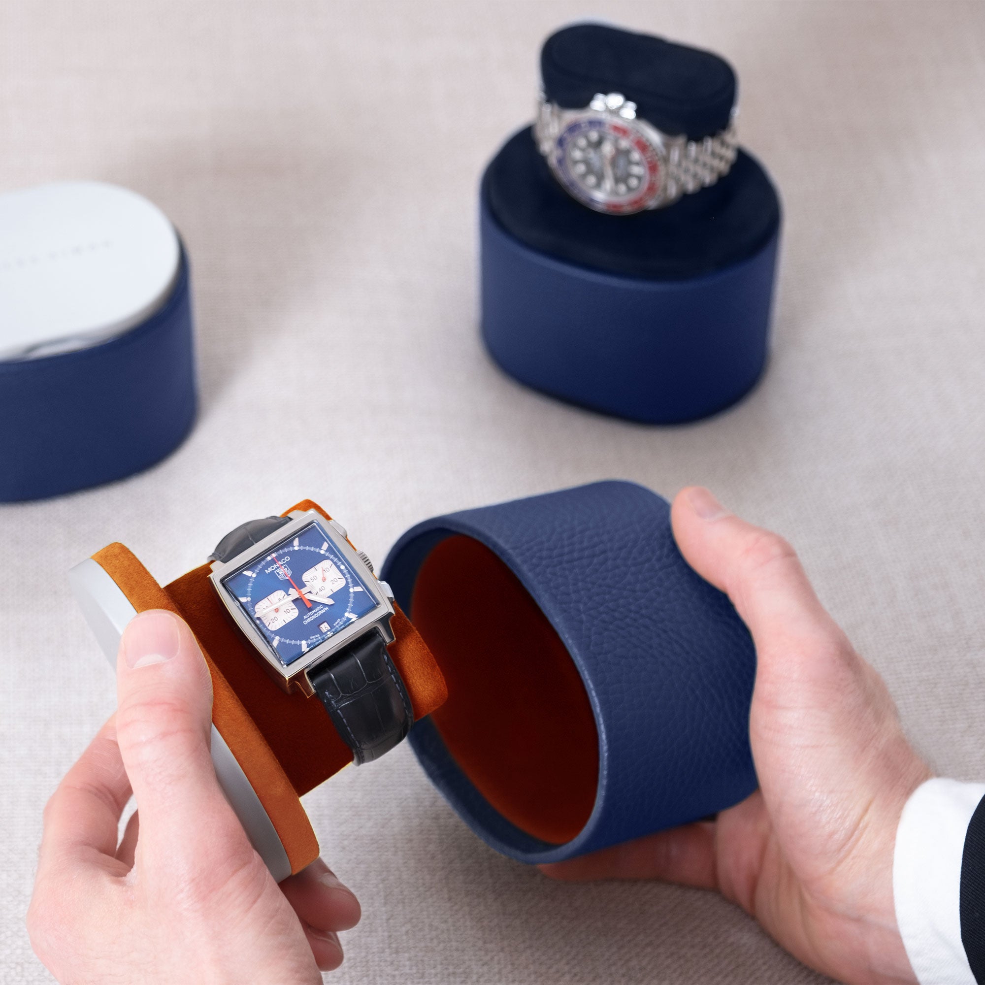 Lifestyle photo of business man holding designer travel watch roll by Charles Simon holding luxury watch.