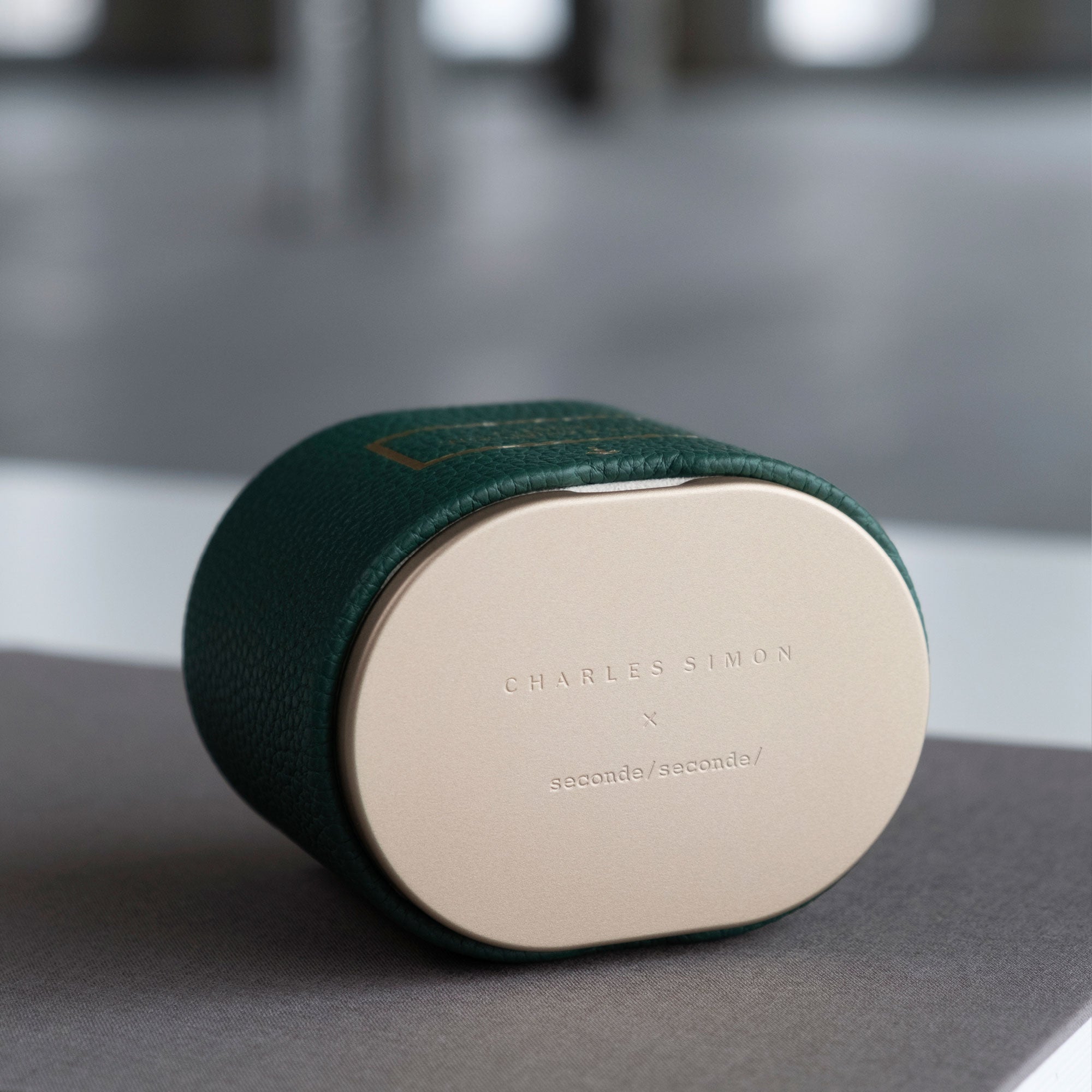 Lifestyle photo of closed limited edition Theo watch roll showing the Charles Simon x seconde/ seconde/ engraving