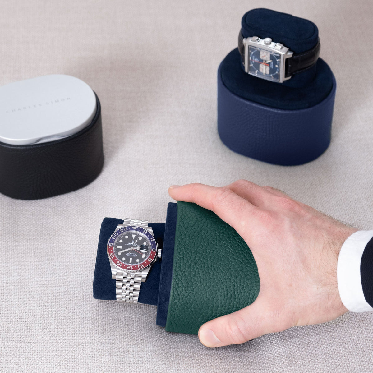 Lifestyle shot of business man grabbing the Theo luxury watch roll for one watch in emerald leather