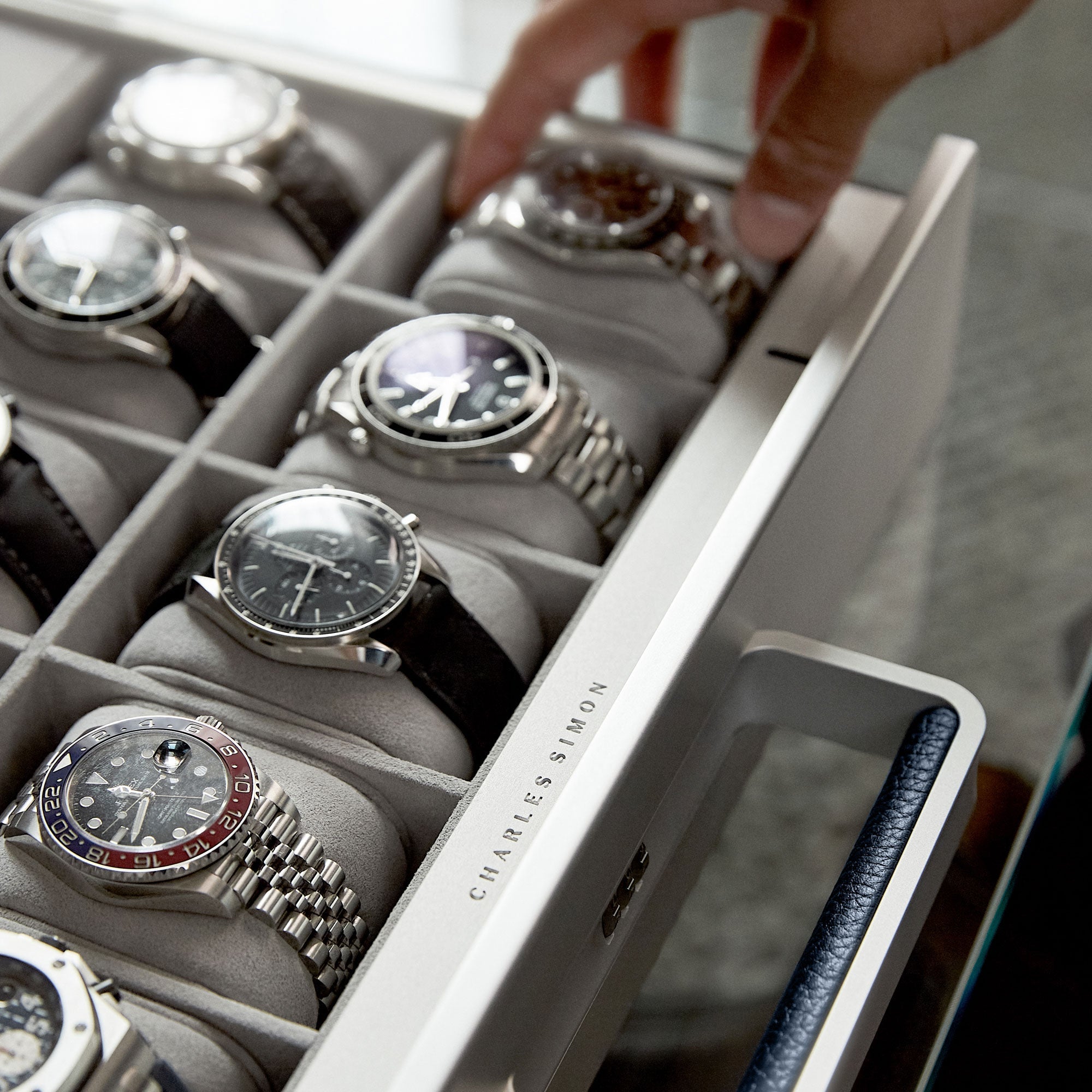 Closeup shot of Mackenzie Watch briefcase 10 containing luxury men's watches on removable Alcantara cushions