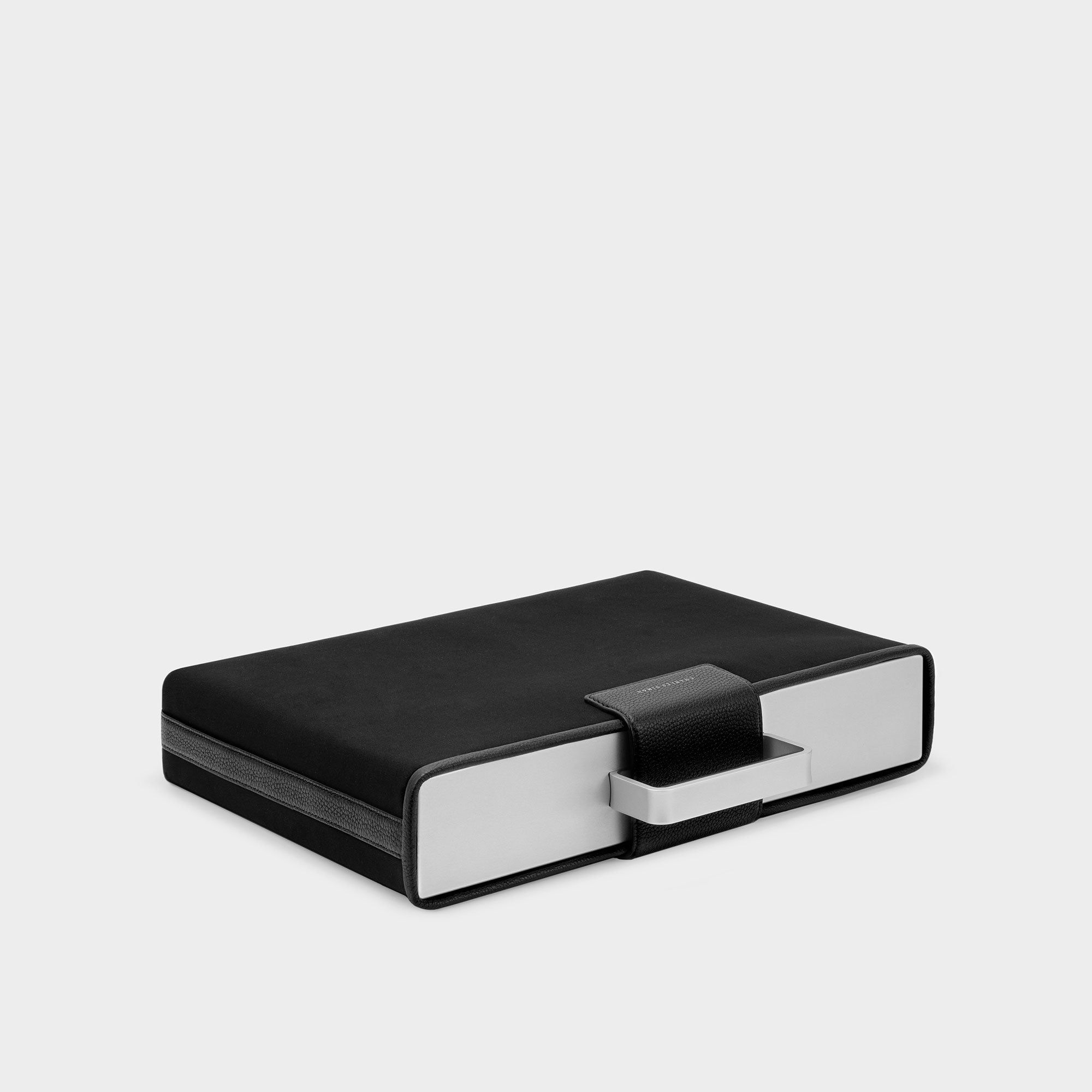 Product photo of black Mackenzie protection cover laying down to show the premium leather of the protective clasp.