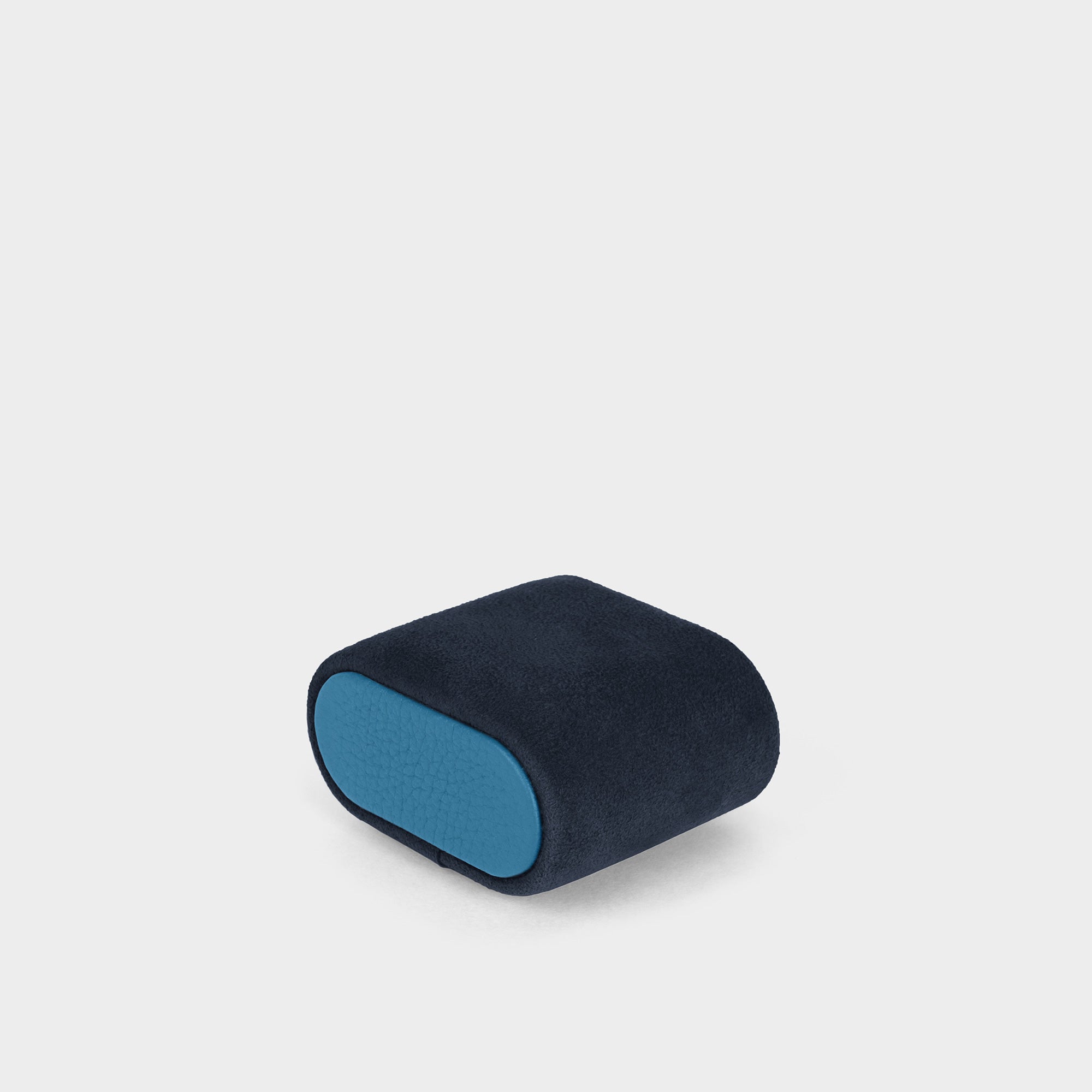 Product photo of watch cushion in deep blue with sky blue leather sides