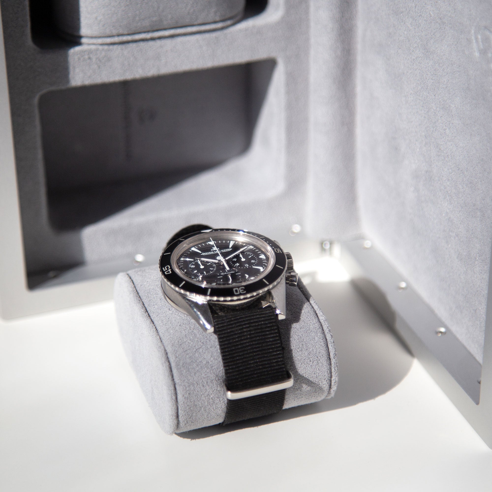 Luxury men's watch placed on removable soft Alcantara cushion from the Eaton 3 watch travel case in cloud grey