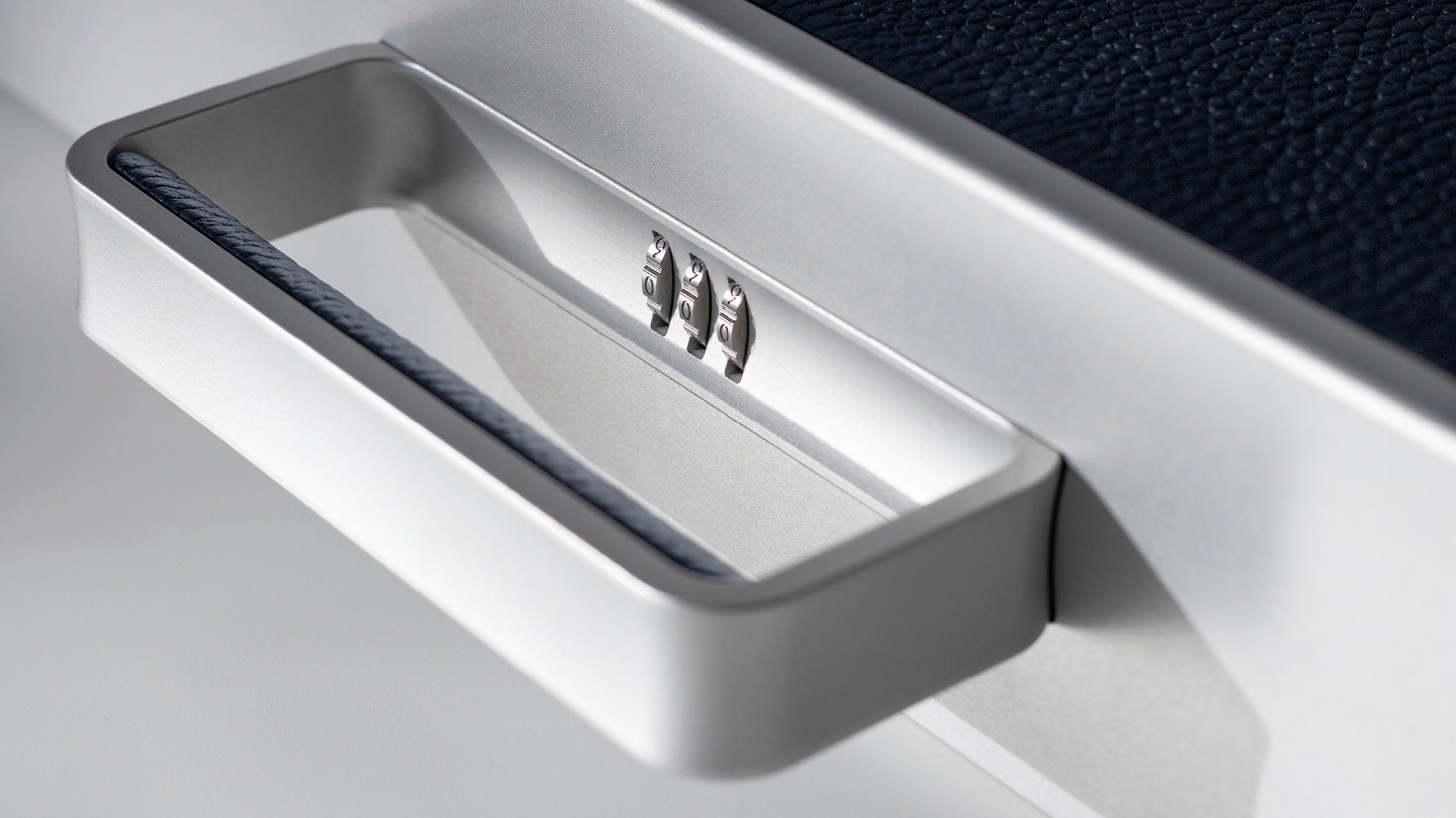 Detail photo of the sleek handle and protective lock of the Mackenzie Briefcase
