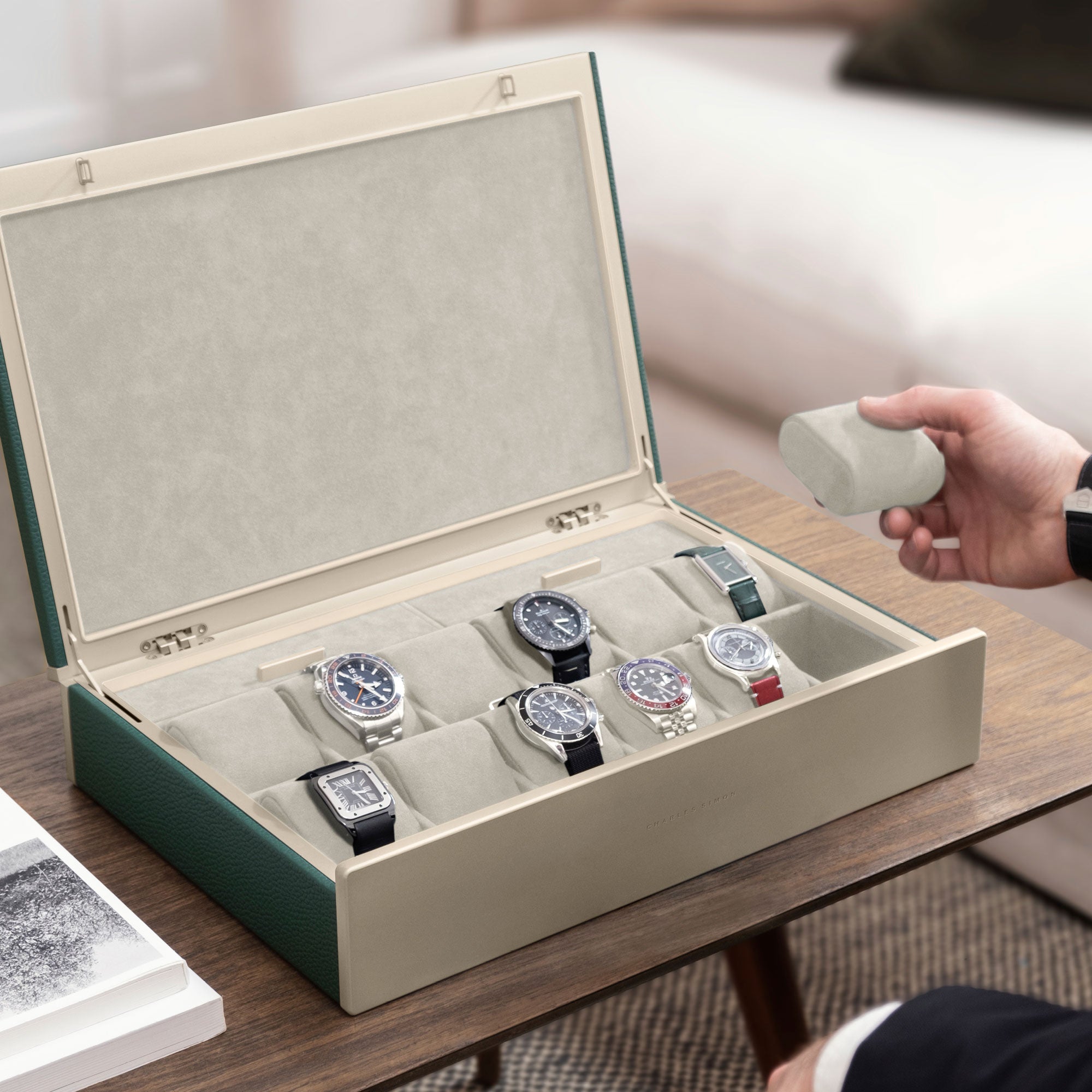 Lifestyle photo of man taking a removable watch cushion in eggshell from his Spence 12 Watch box