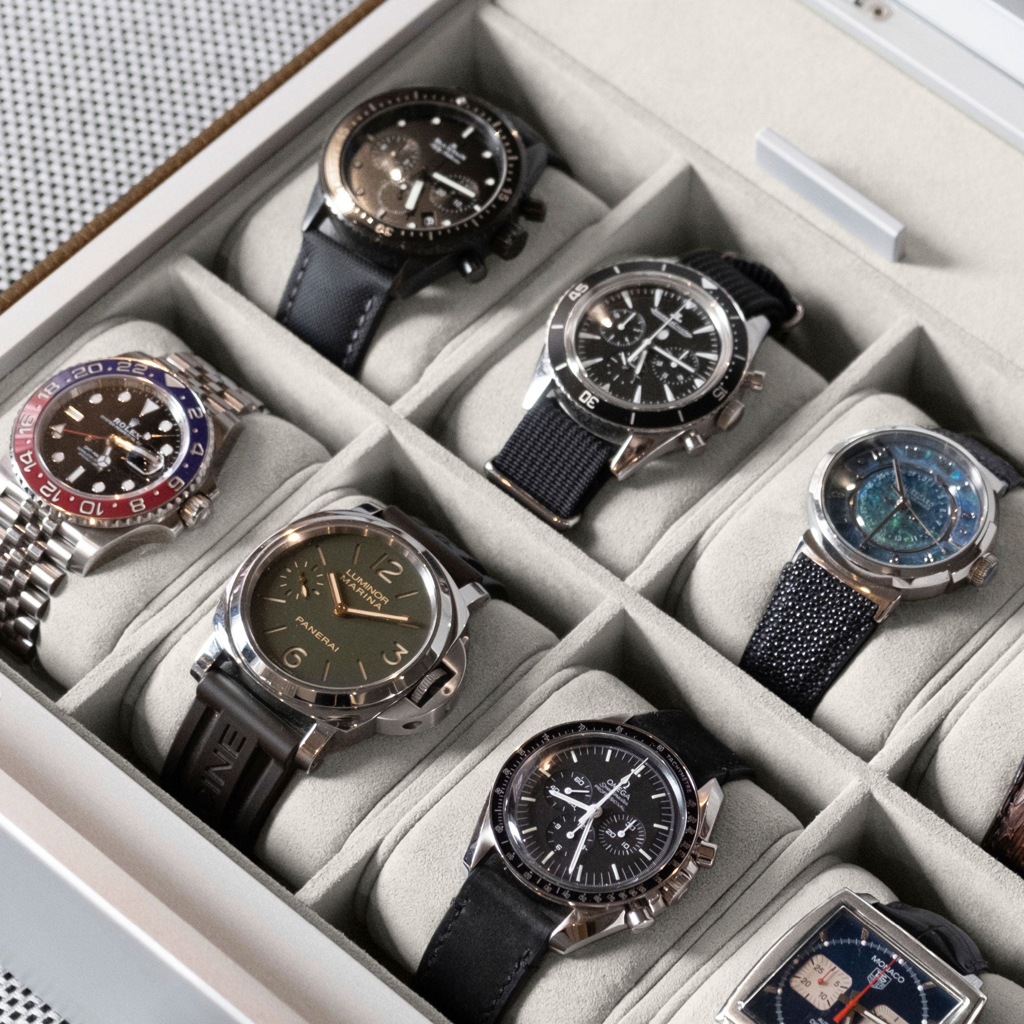 Luxury watch collection stored in handmade Spence 12 luxury Watch box in tan leather and eggshell Alcantara interior