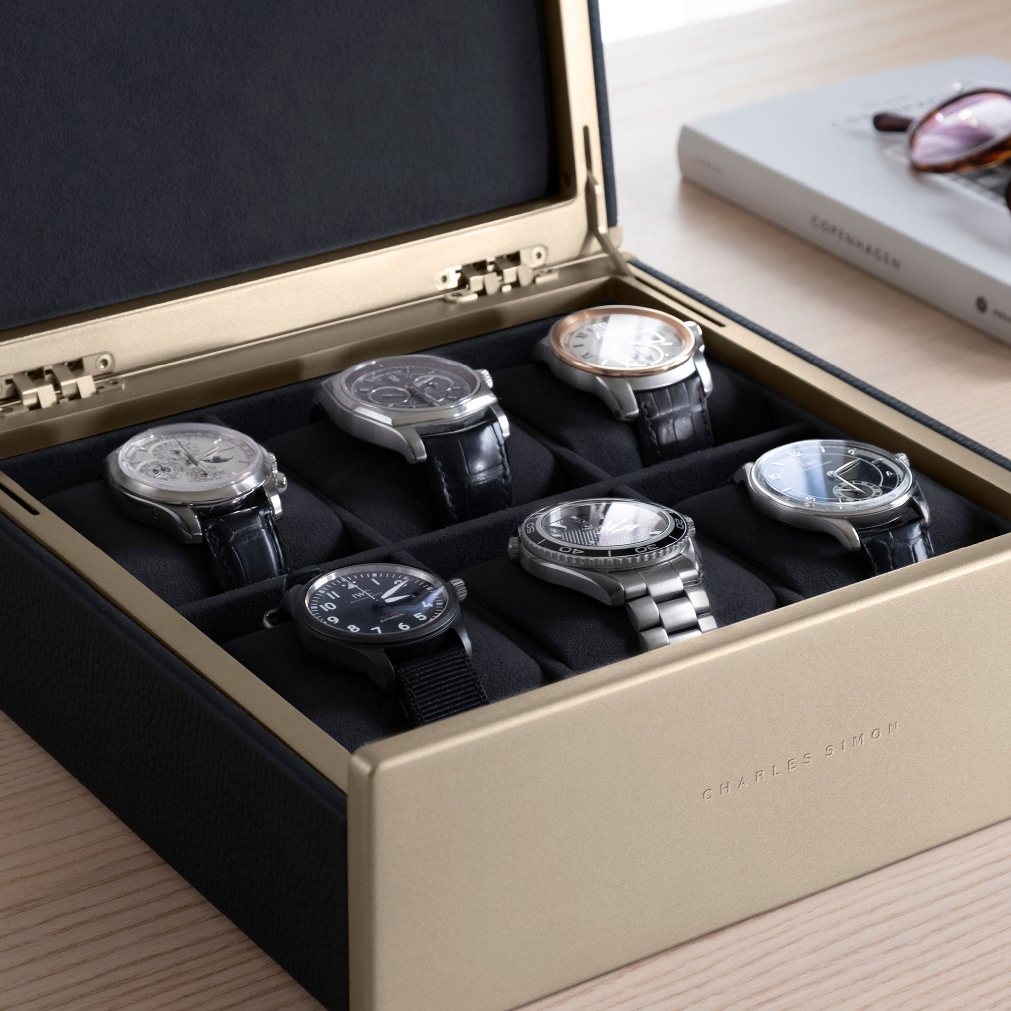 Detail photo of watch collection of 6 watches displayed in the gold Spence 6 watch box in black leather.