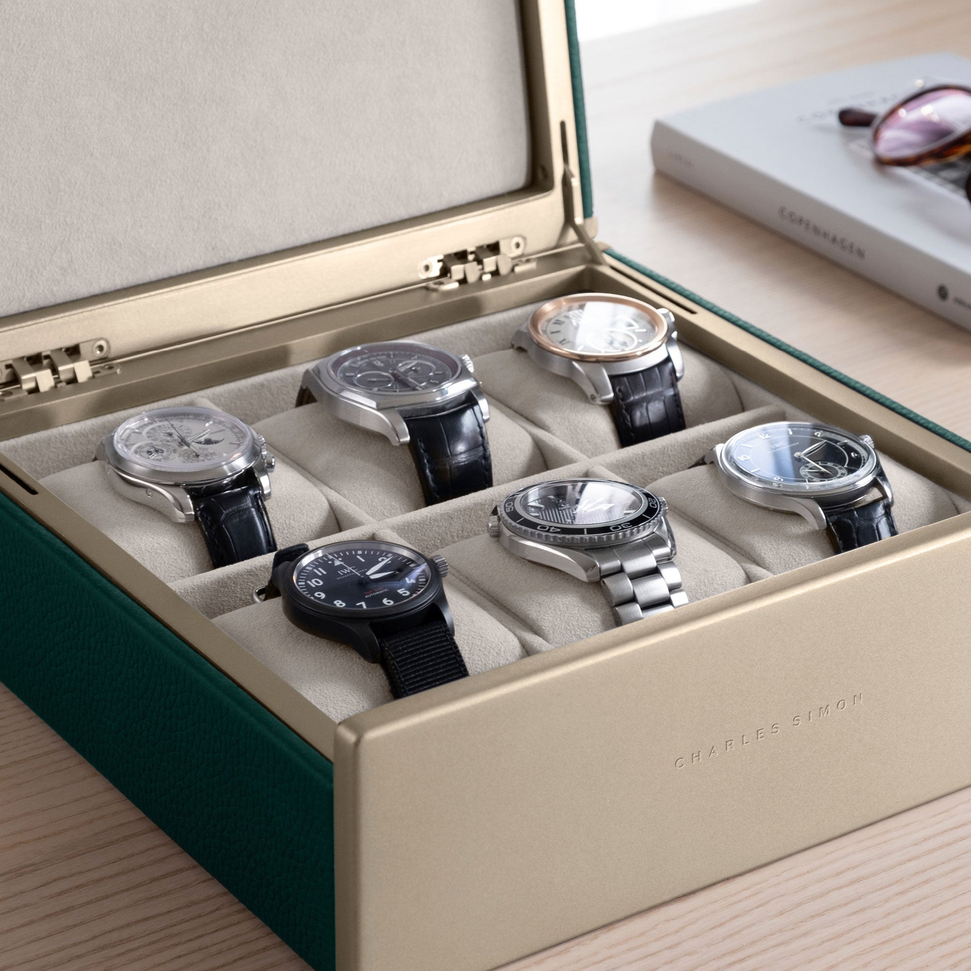 Detail photo of watch collection of 6 watches displayed in the gold Spence 6 watch box in emerald leather.