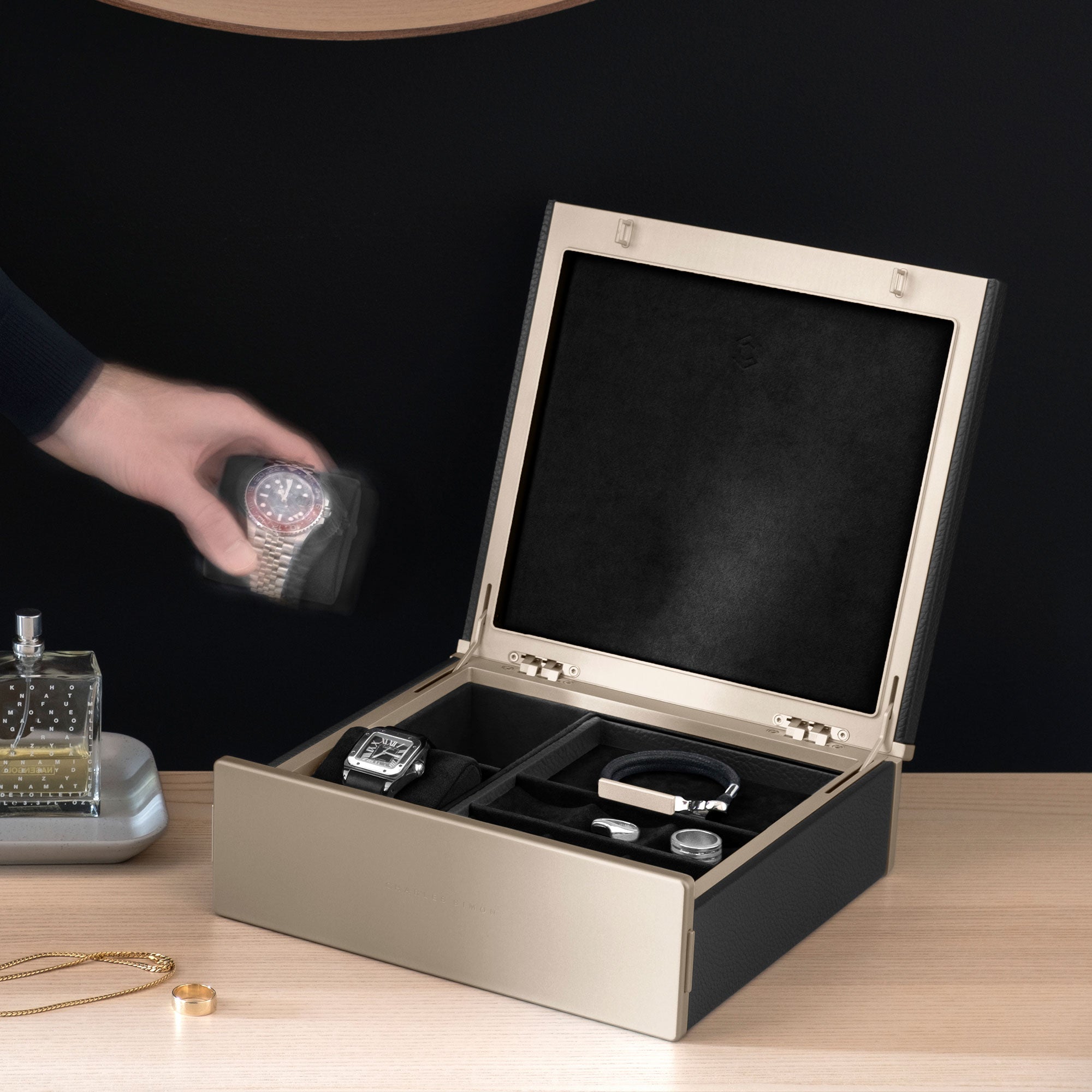 Lifestyle photo of black Taylor 2 gold watch and jewelry box for an entire collection of watches and jewelry.
