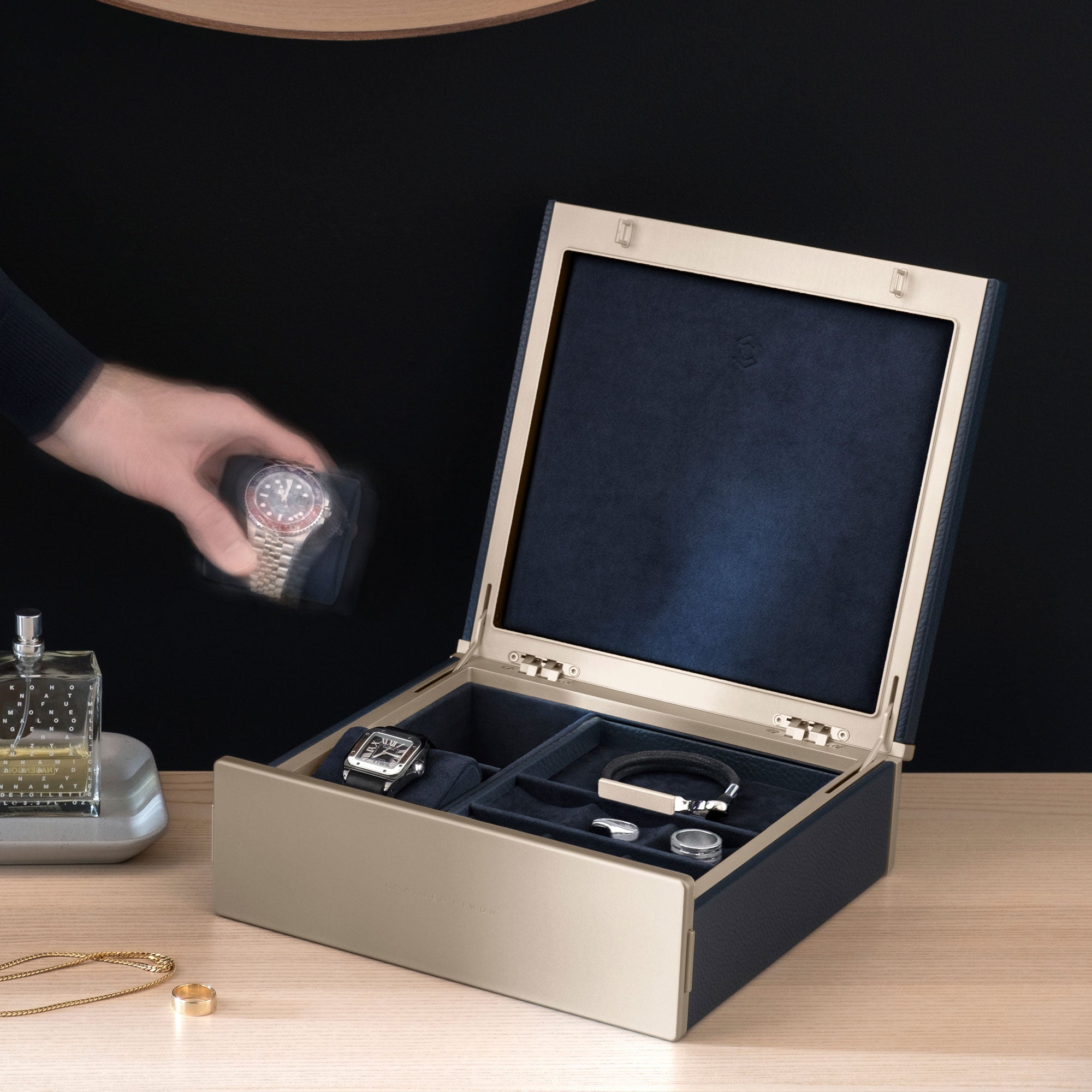 Lifestyle photo of marine Taylor 2 gold watch and jewelry box for an entire collection of watches and jewelry.