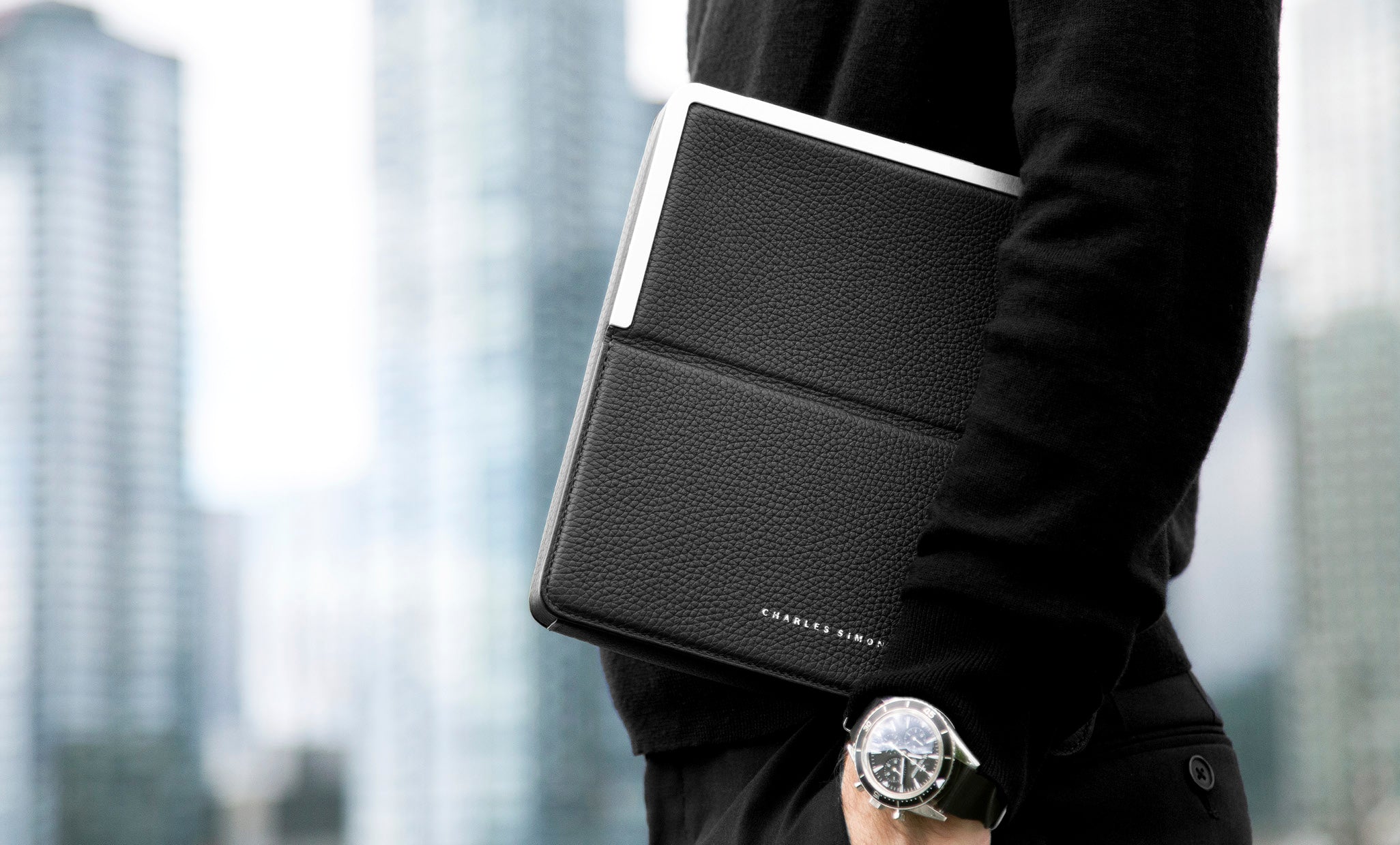 Fraser travel wallet by Charles Simon, man holding luxury travel wallet