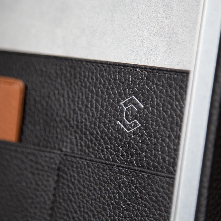 Closeup shot of Charles Simon logo on interior leather pocket of the Mackenzie briefcase