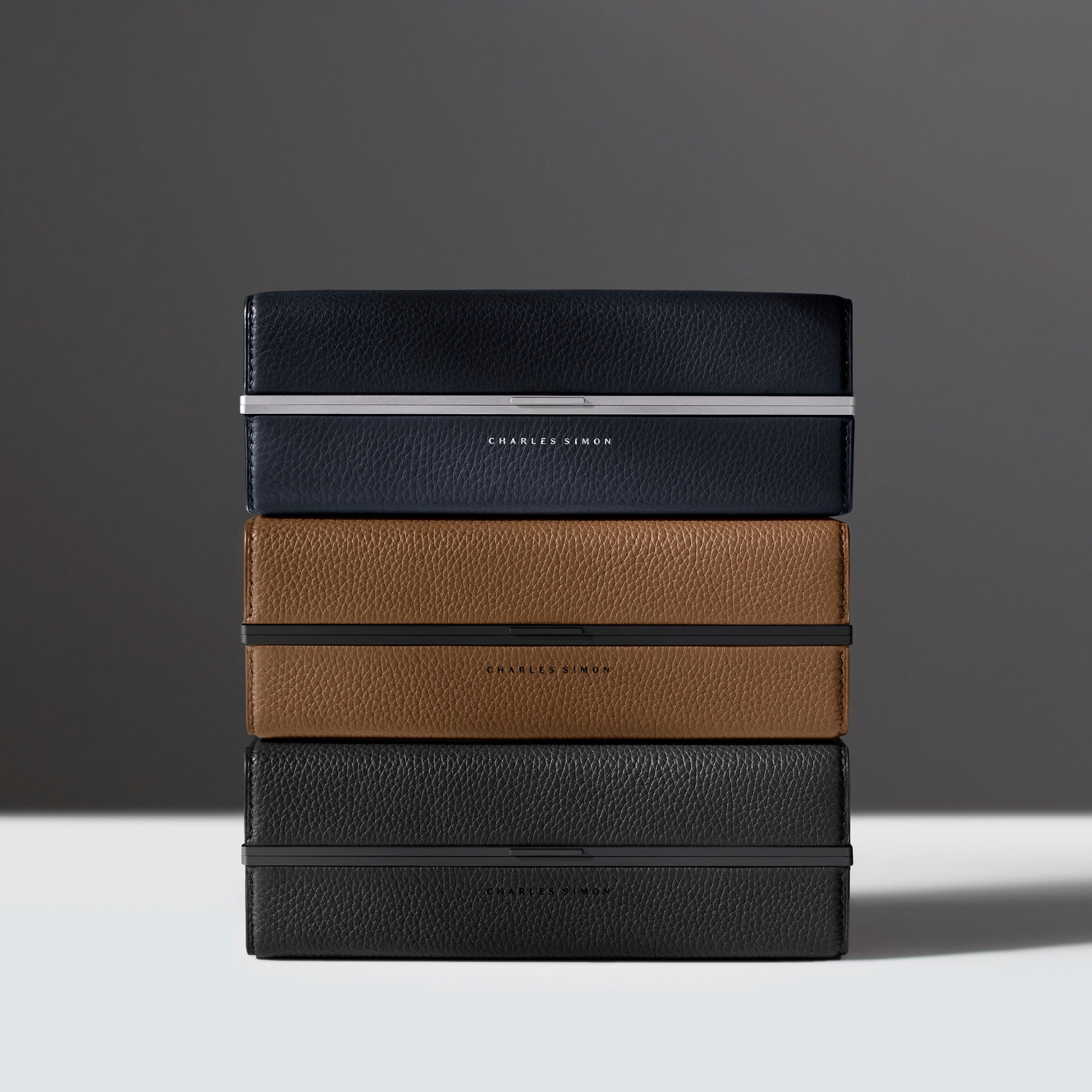 Three elegant Moraine Toiletry cases stacked on top of each other. Handmade in Canada featuring timeless design.