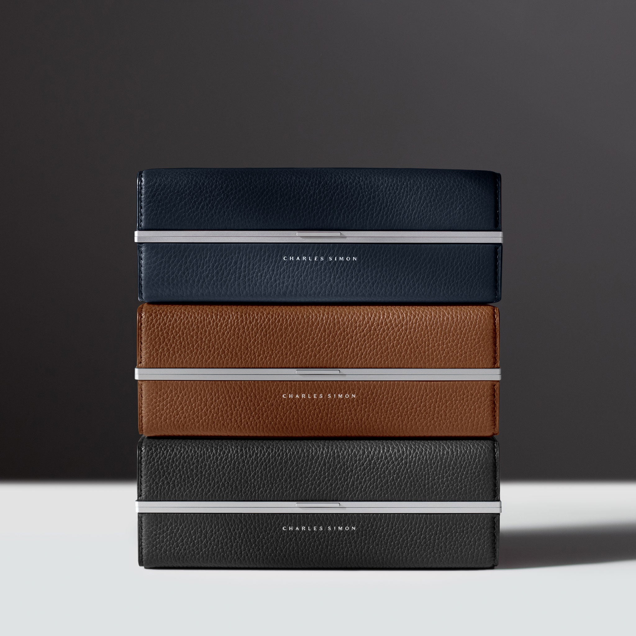 Lifestyle photo of 3 stacked Moraine Toiletry bags made from premium materials and handcrafted in Canada.