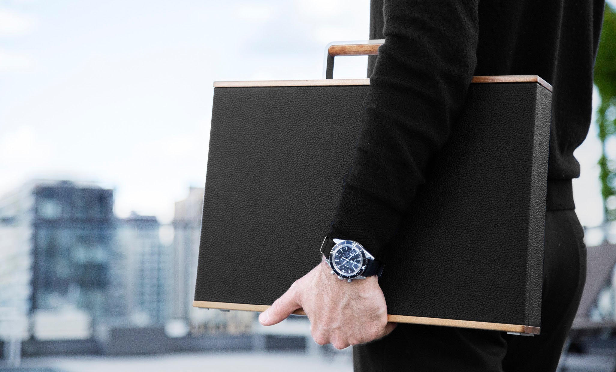 Mackenzie original briefcases, man holding black briefcase with wooden details, travel briefcase