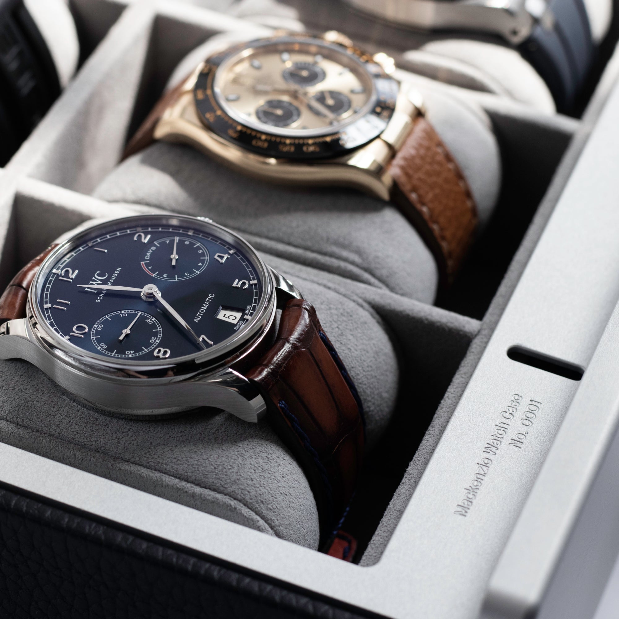 Closeup shot of luxury watches placed on soft, removable cushions in marine leather watch case by Charles Simon