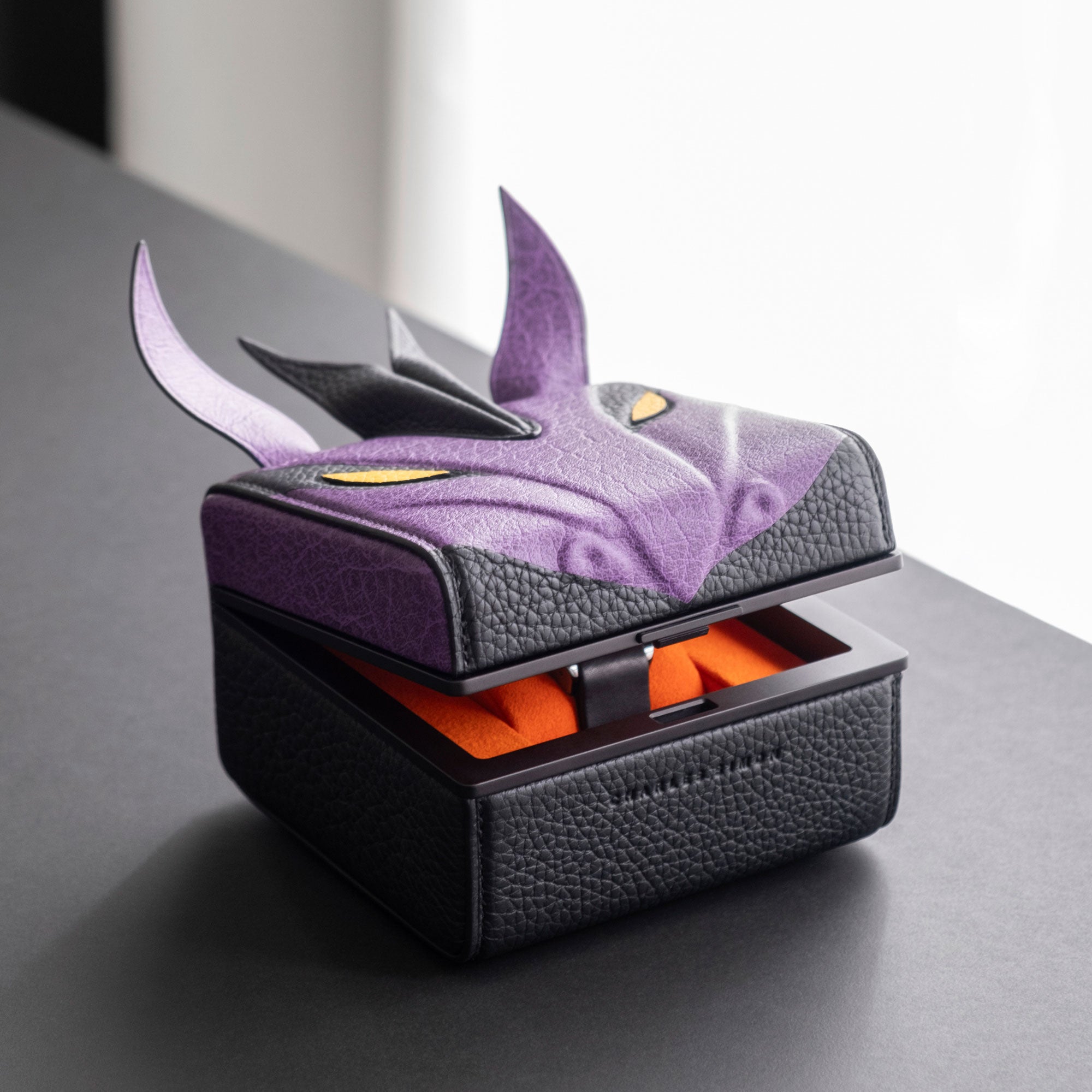 Lifestyle photo of the purple dragon watch case showcasing the accessory holding one watch and keeping it safe. 