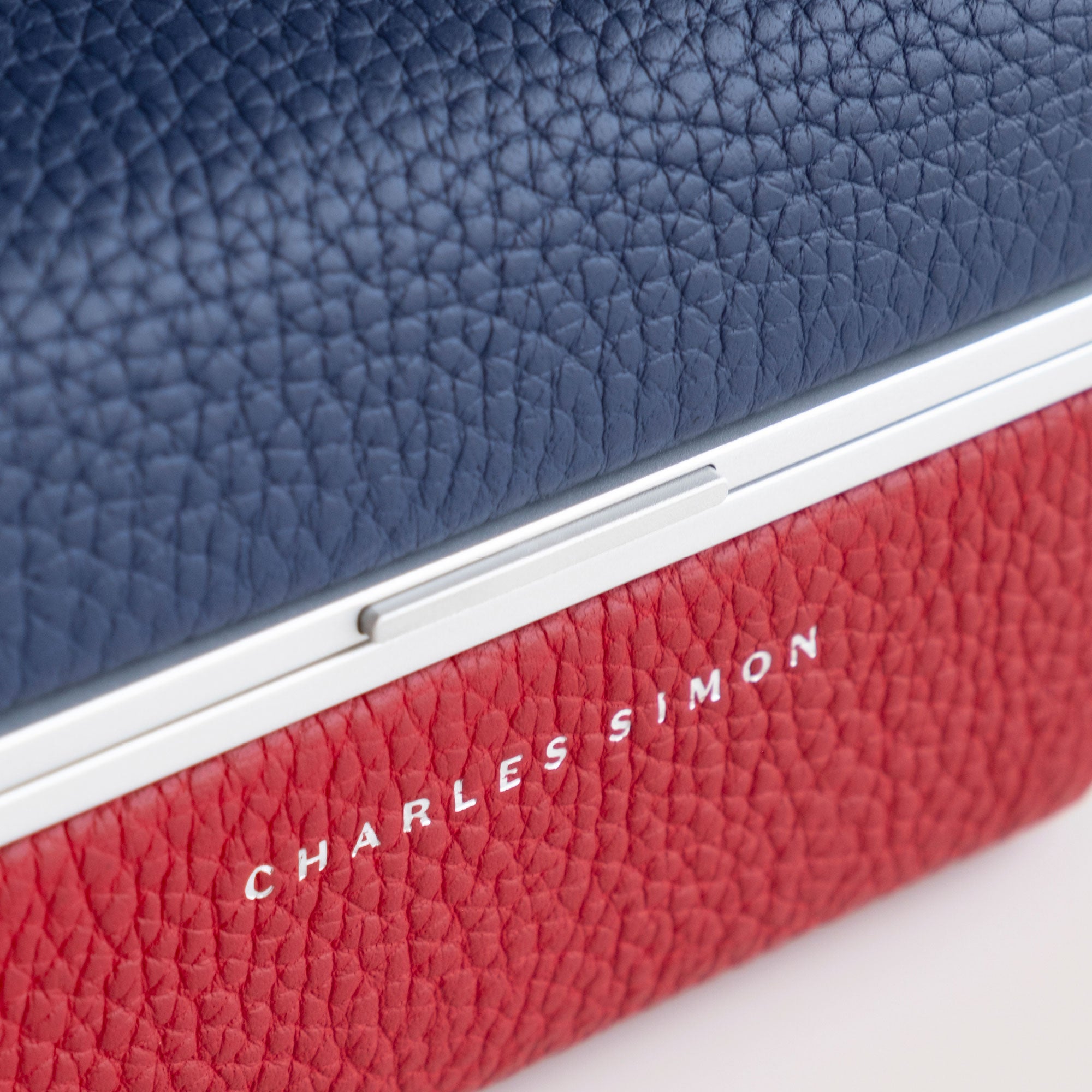 Closeup of the leather color combination in sapphire and red on the Charles Simon Eaton 1 Special Edition Watch case. The perfect complement to the Rolex GMT Master II.