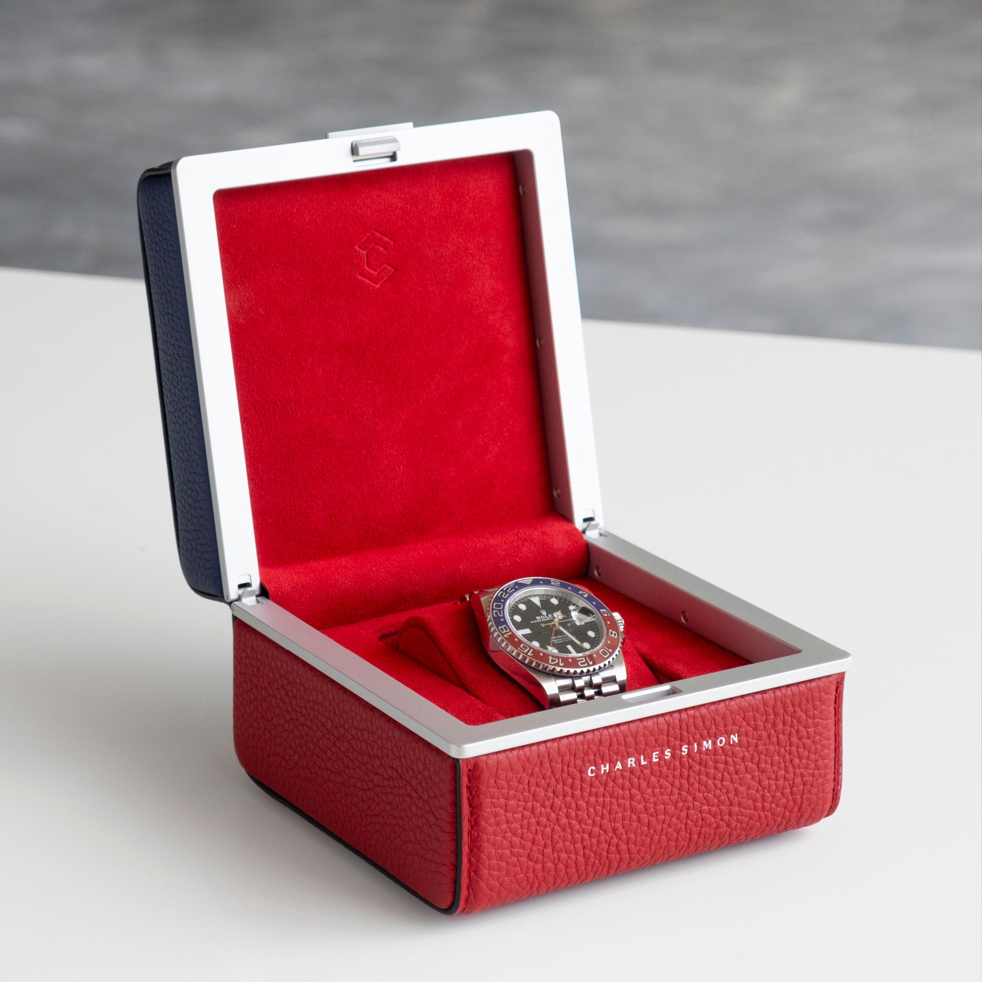 Lifestyle photo of Rolex GMT Master II displayed in matching Eaton 1 Special Edition Watch case